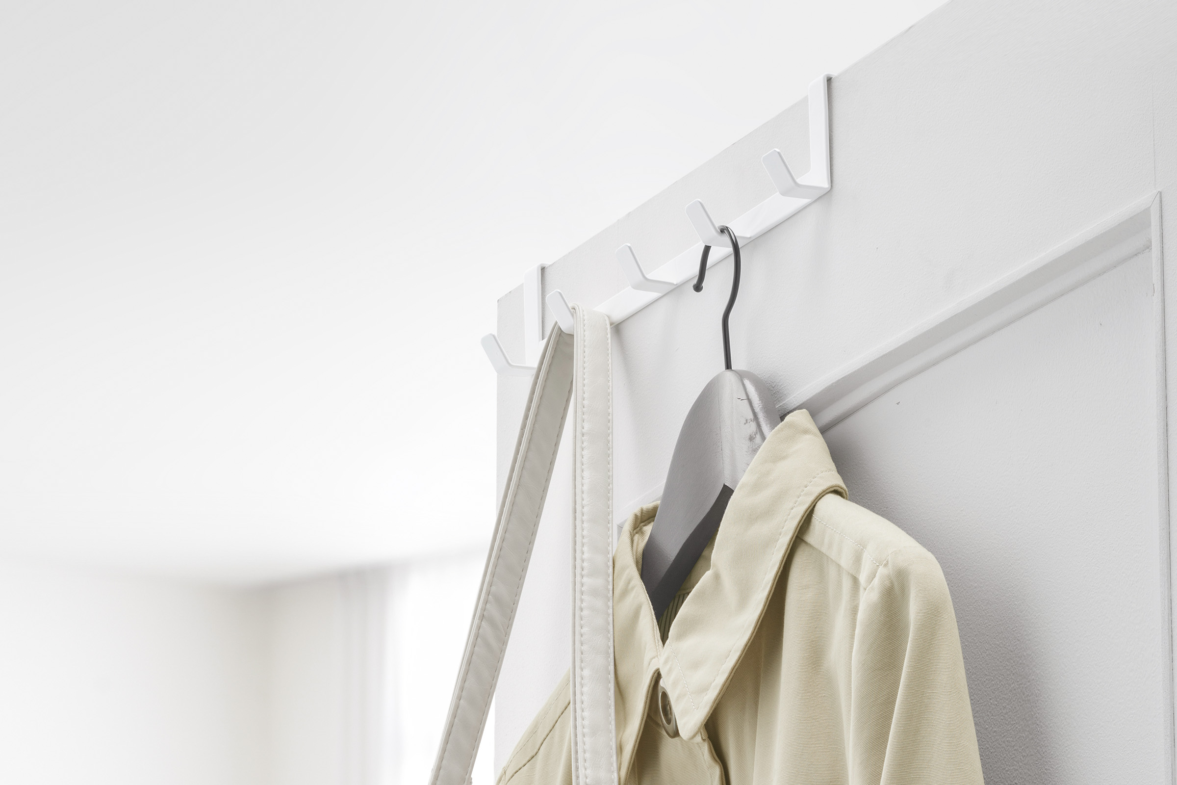 White Yamazaki Over-the-Door Hanger with a jacket and bag hung up