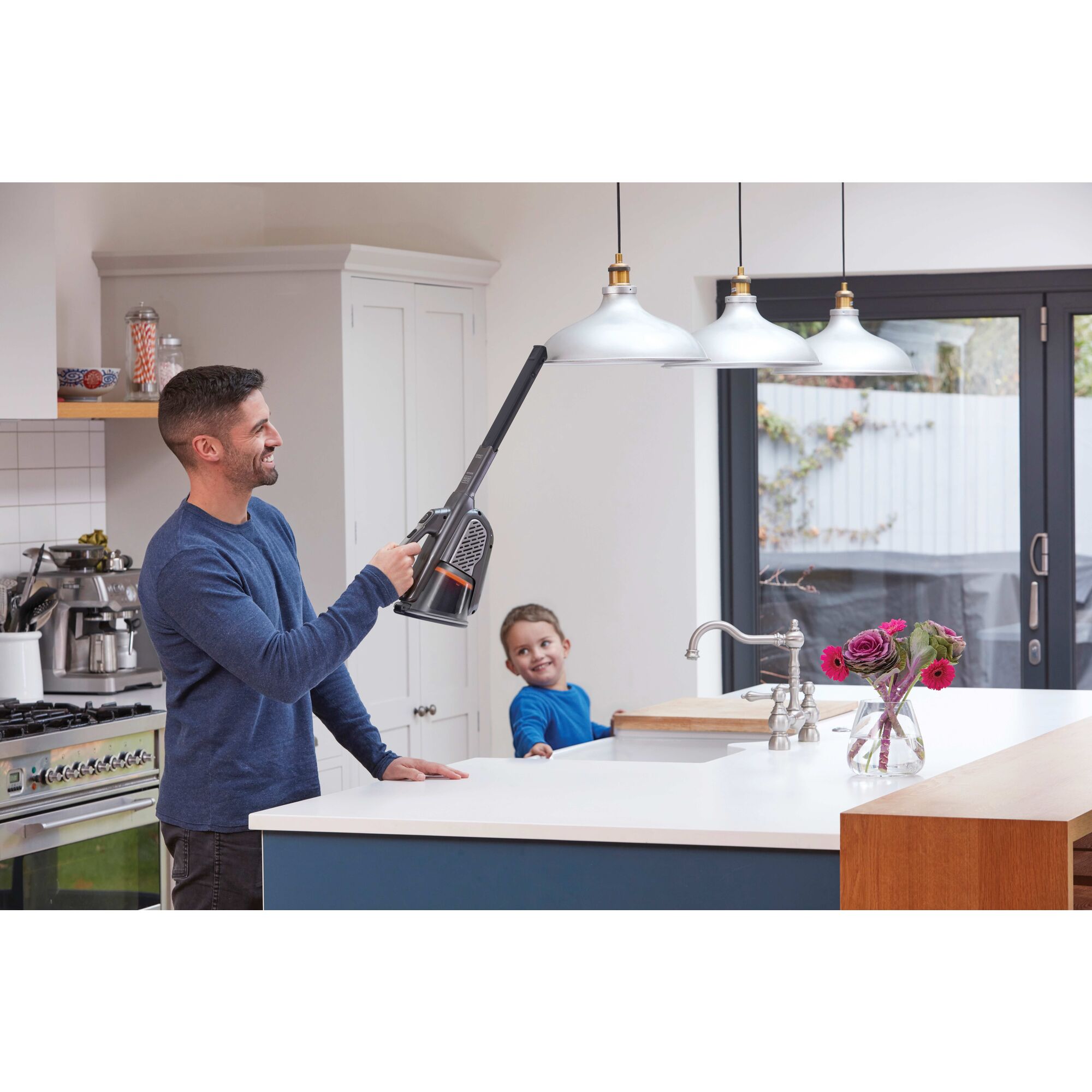 16 Volt Dust buster Advanced Clean Hand Vacuum being used by a person on hanging lights.