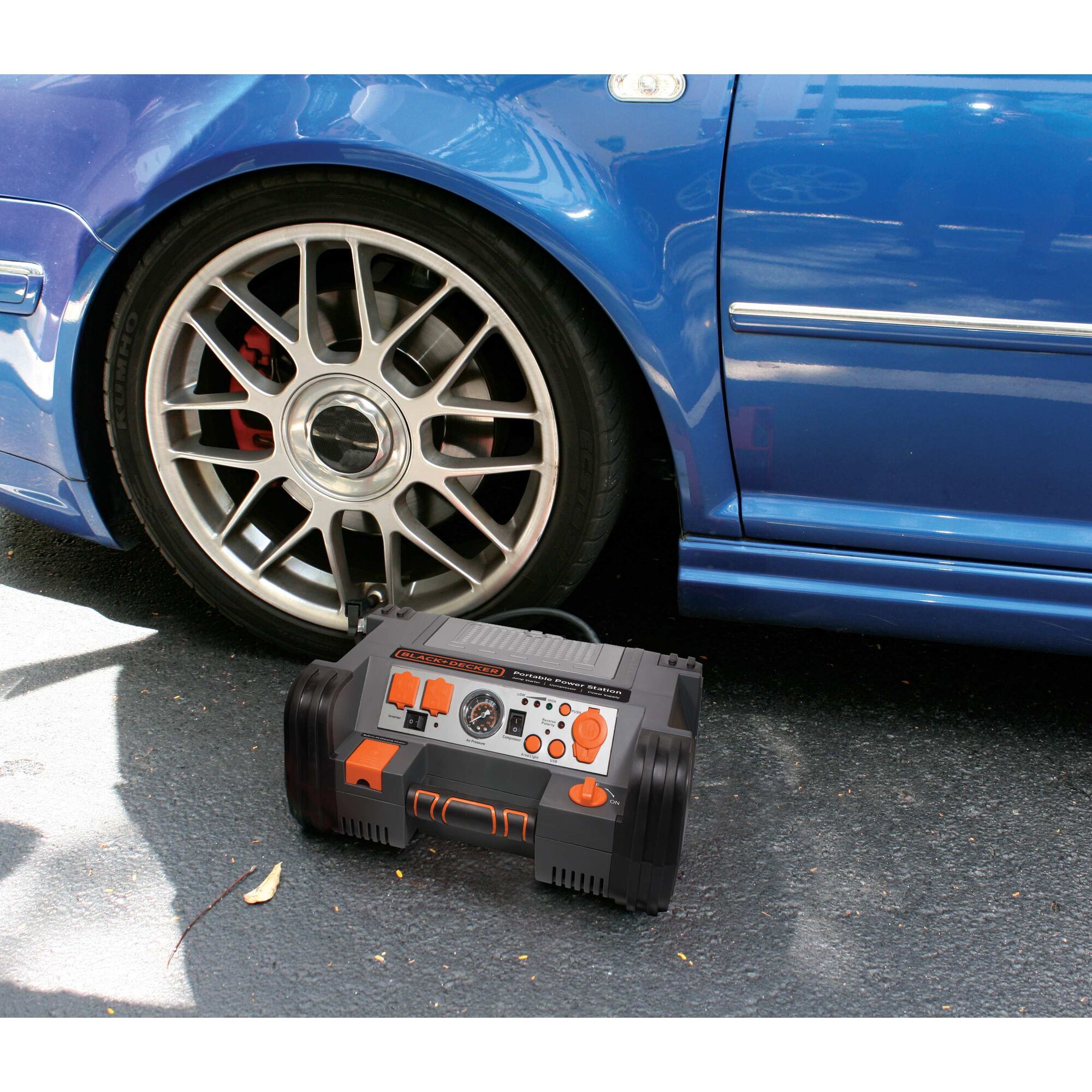 Battery Charger and Maintainer being used to inflate tire of car.
