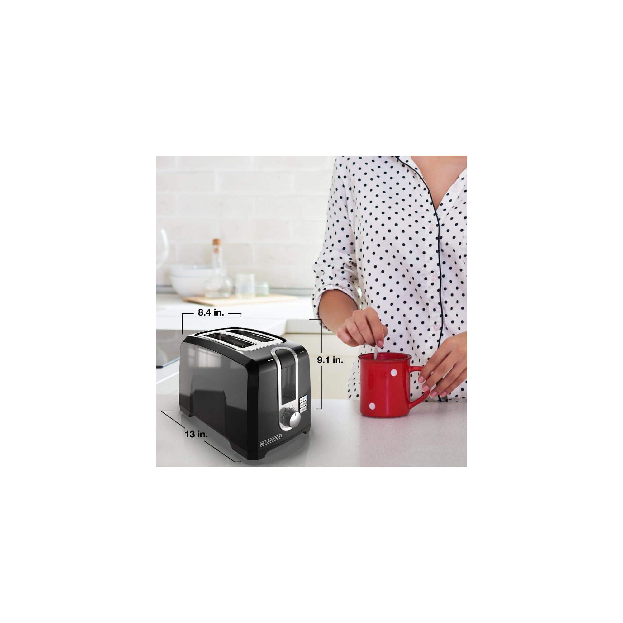Person eating bagel and having coffee near the BLACK+DECKER 2 slice toaster
