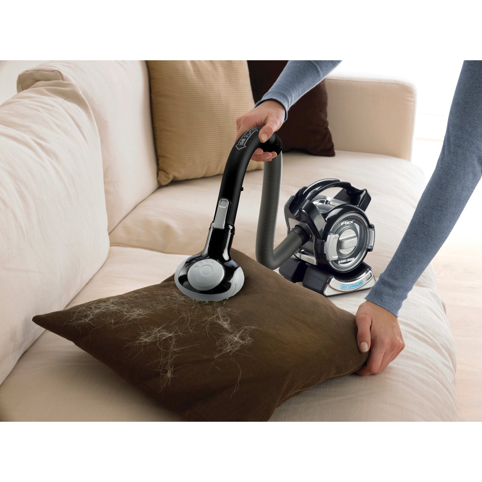 Dustbuster flex cordless hand vacuum with floor head plus pet hair brush being used by a person.