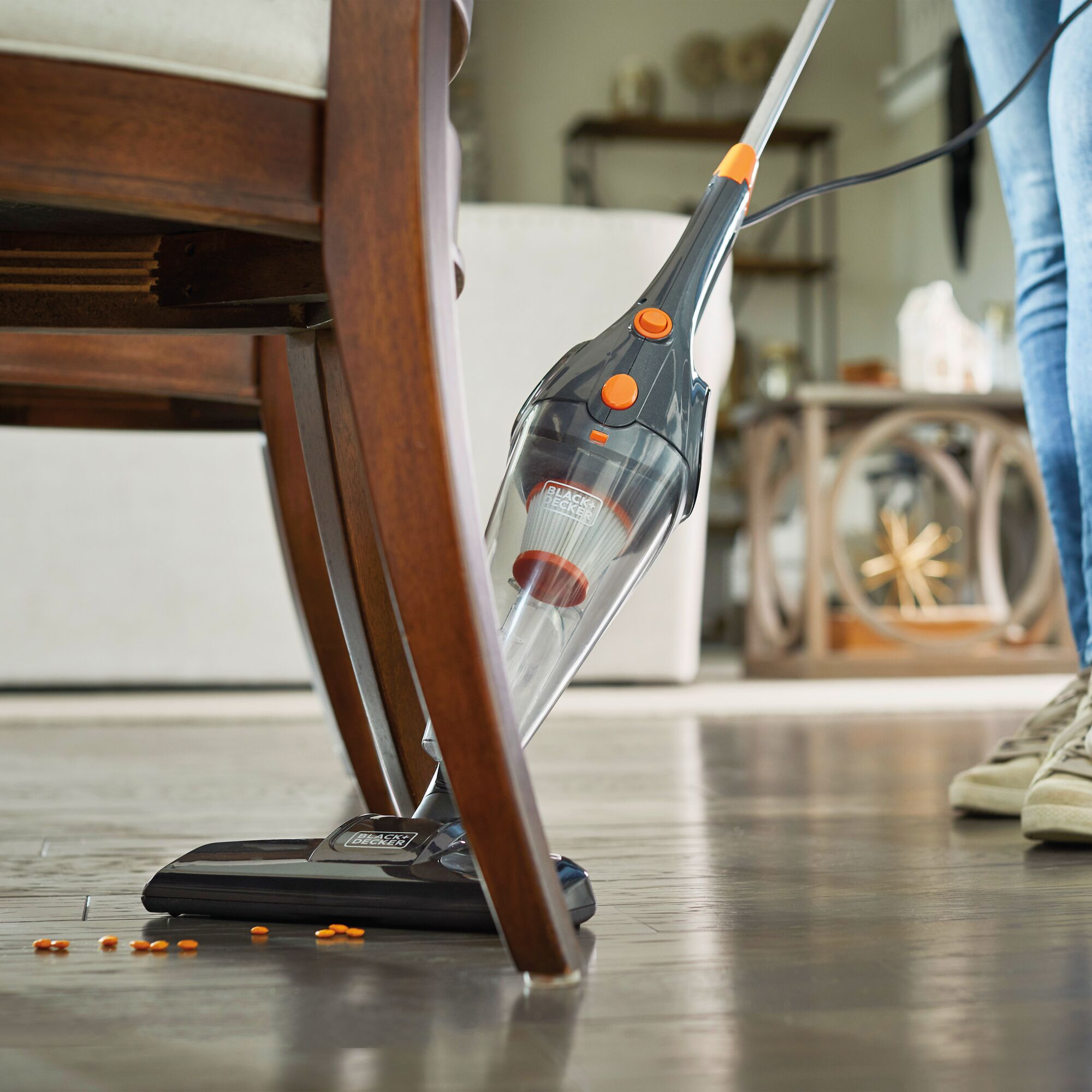Close-up of 3In1 Upright Stick Vacuum Cleaner vacuuming under kitchen chairs.