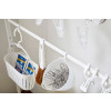 Close up view of white Rolling Cleaning Rack hooks holding cleaning supplies by Yamazaki Home.
