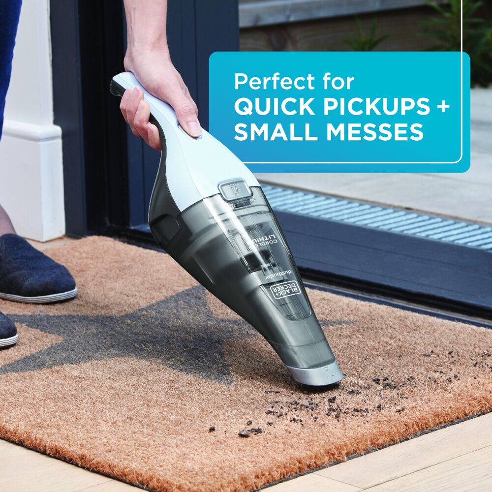 Person using HNVC215B12AEV BEYOND BY BLACK+DECKER Cordless Dustbuster - Handheld Vacuum Cleaner to clean up mess: Perfect for quick pickups + small messes