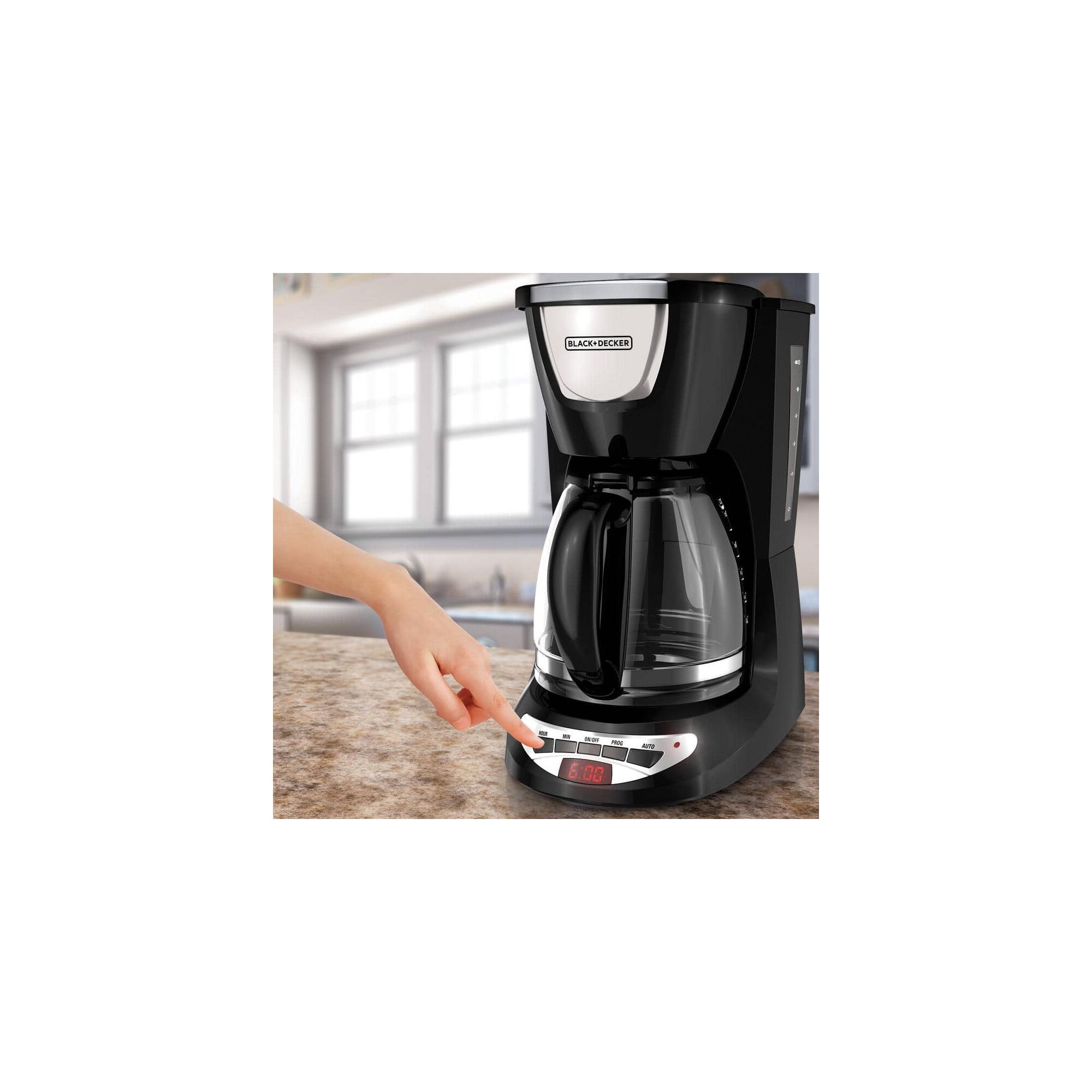 Person pushing the controls of the BLACK+DECKER coffee maker