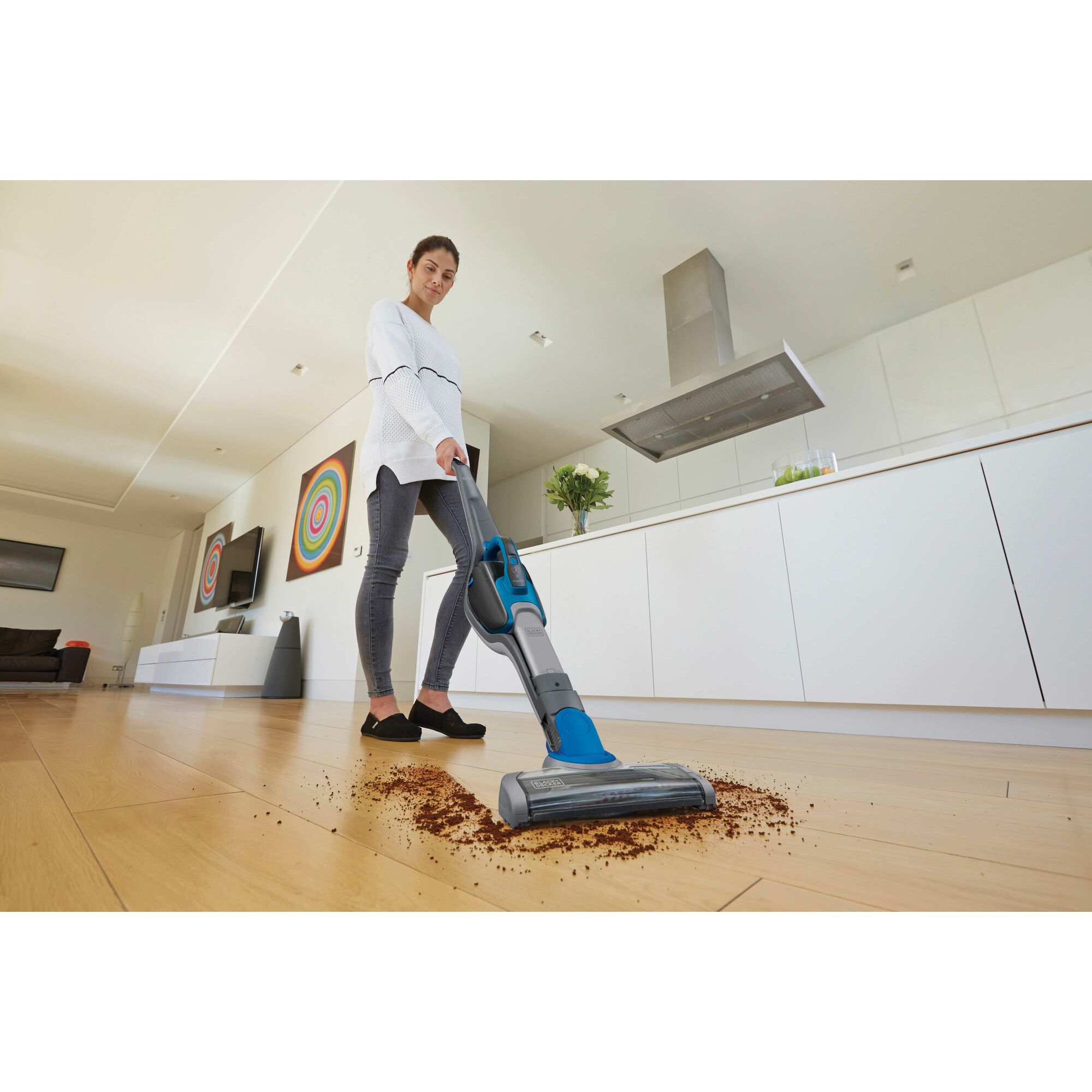 Cordless Lithium 2 in 1 Stick Vacuum being used for cleaning dirt on floor.