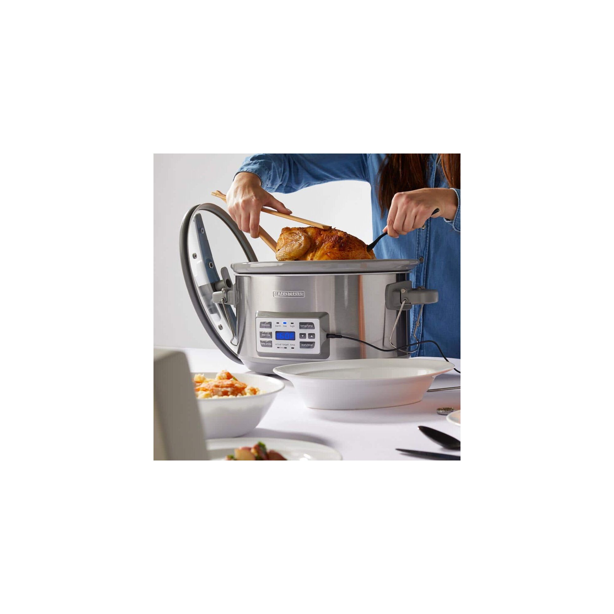 Person cooking with the BLACK+DECKER 7 quart digital slow cooker