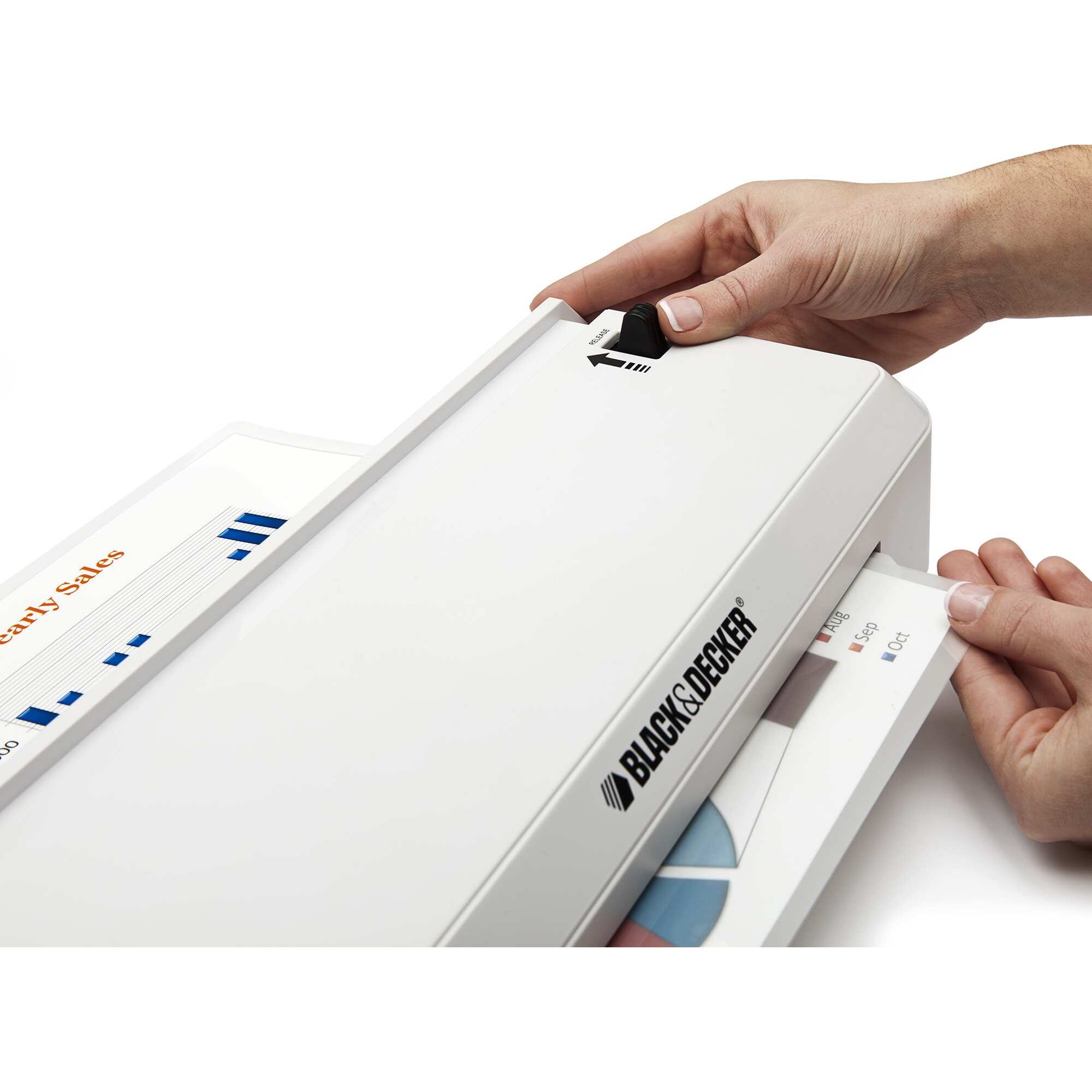 Flash 9.5 inch thermal laminator being used to laminate a sheet of paper.