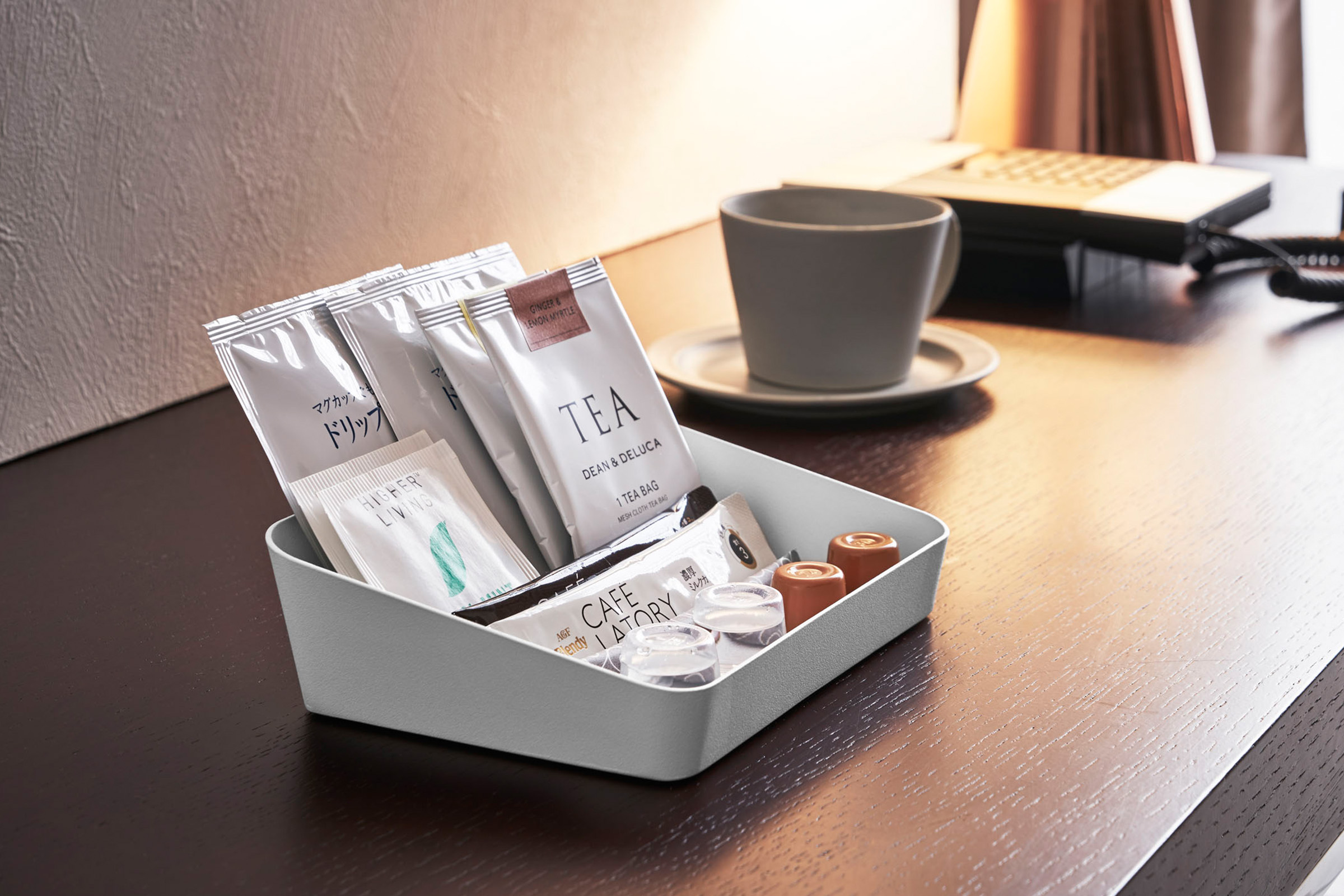 Small Angled Vanity Tray by Yamazaki Home in white on a table with coffee and tea items.