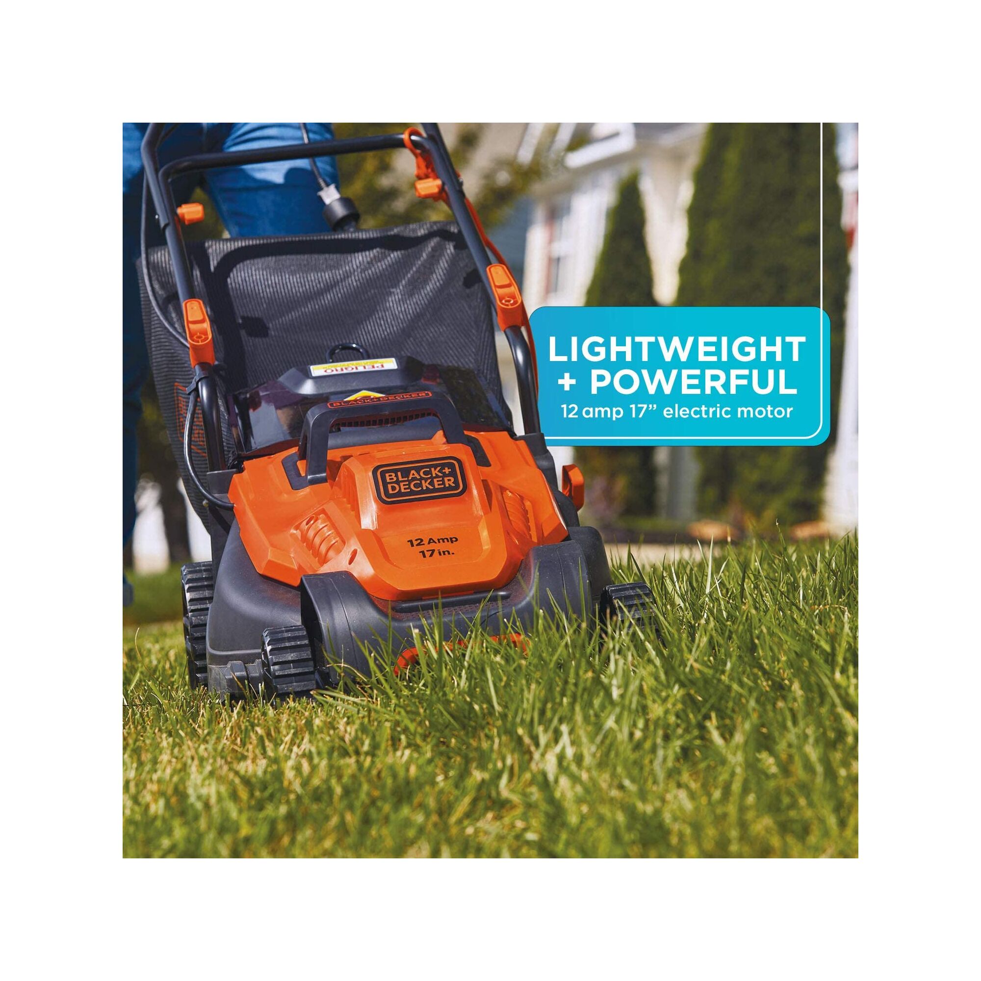 Black and decker 12 amp 17 inch electric lawn mower with comfort grip handle being used.