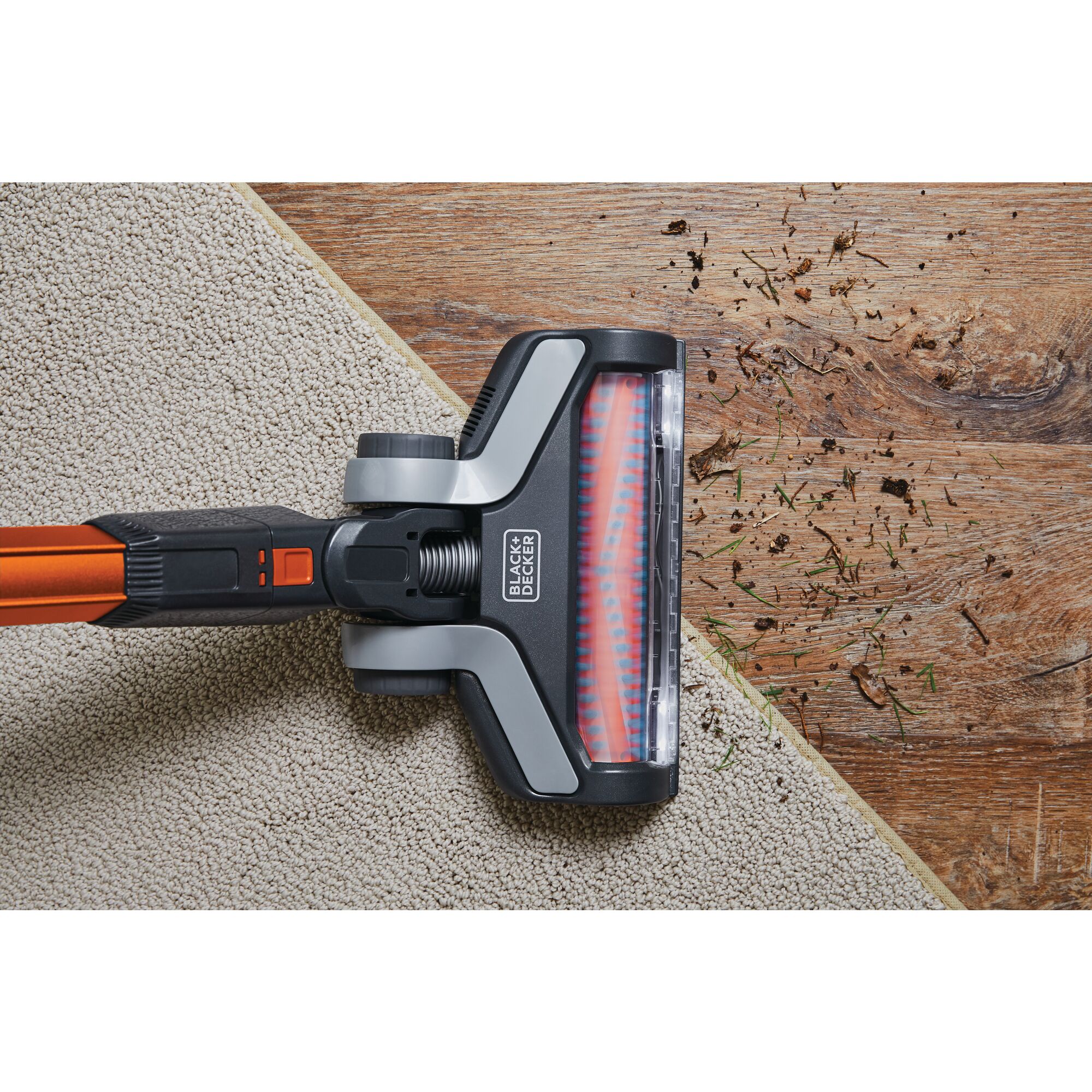 POWER SERIES Extreme Cordless Stick Vacuum Cleaner being used to clean debris from rug and wooden floor.