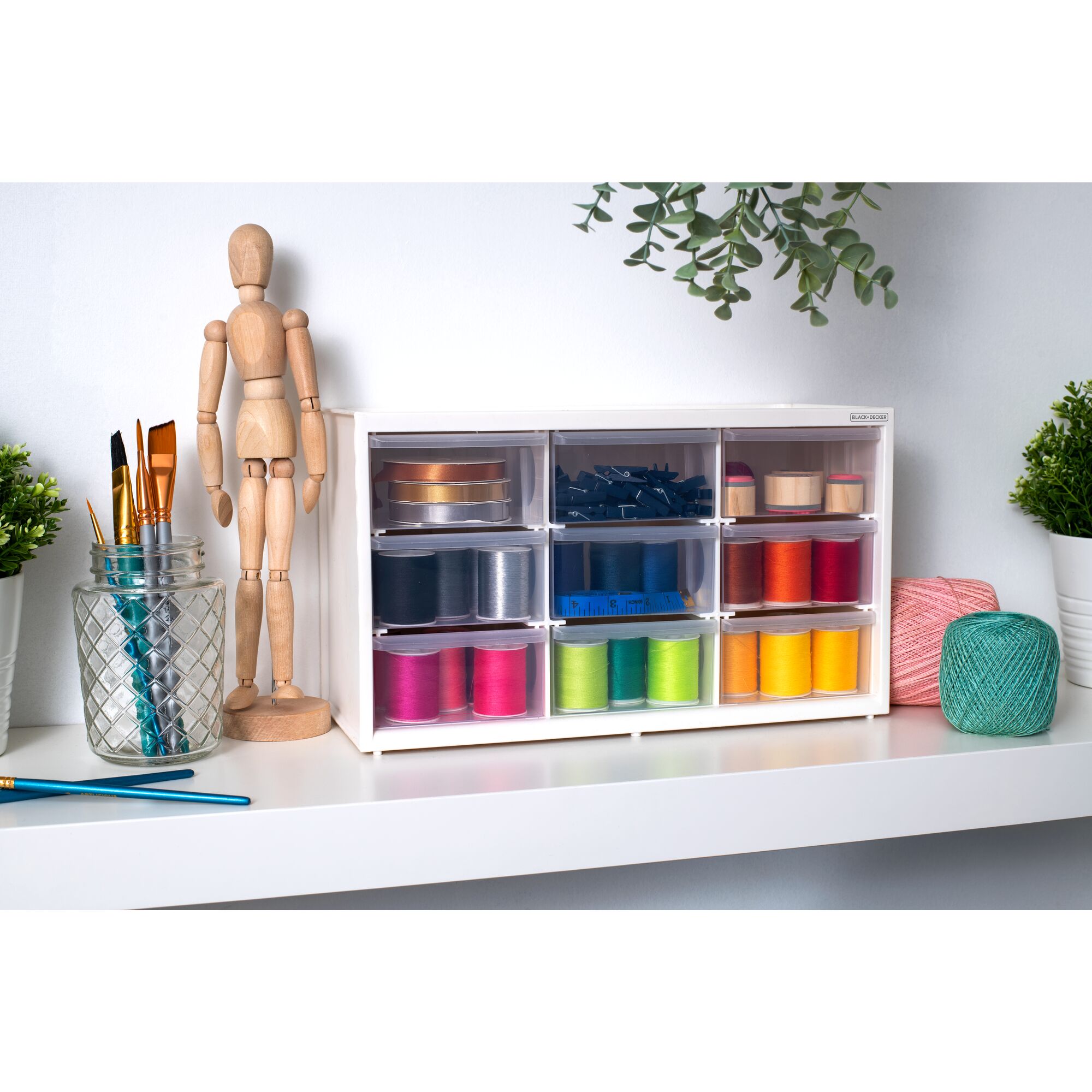 BLACK+DECKER 9 drawer material bin filled with threads of varying colors sitting on a shelf