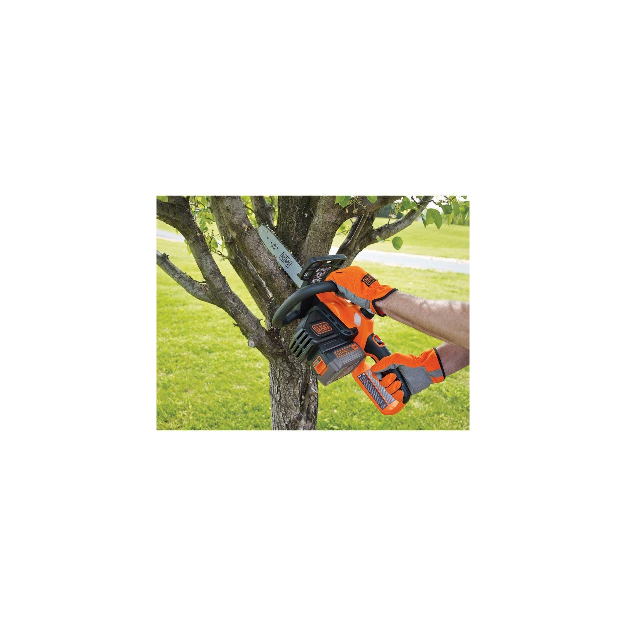 Person using chainsaw to cut tree limbs