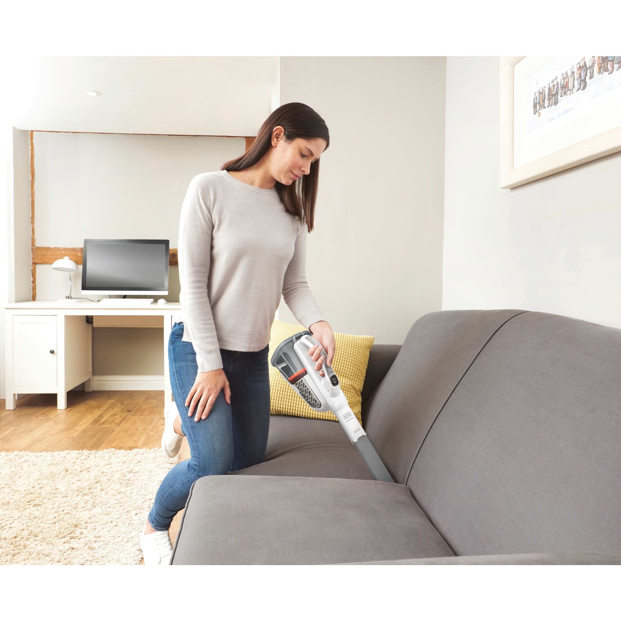 Dustbuster Advanced Clean plus  Cordless Hand Vacuum being used to clean hard to reach places of sofa.