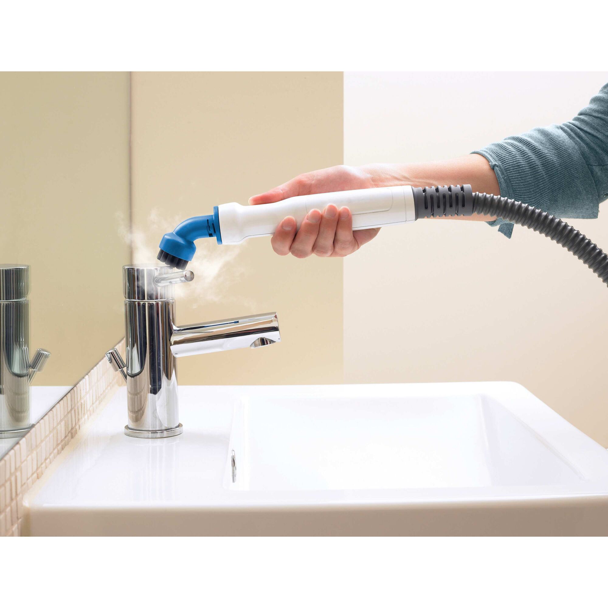 7 in 1 Steam Mop with SteamGlove handheld steamer being used by a person to clean tap handle.