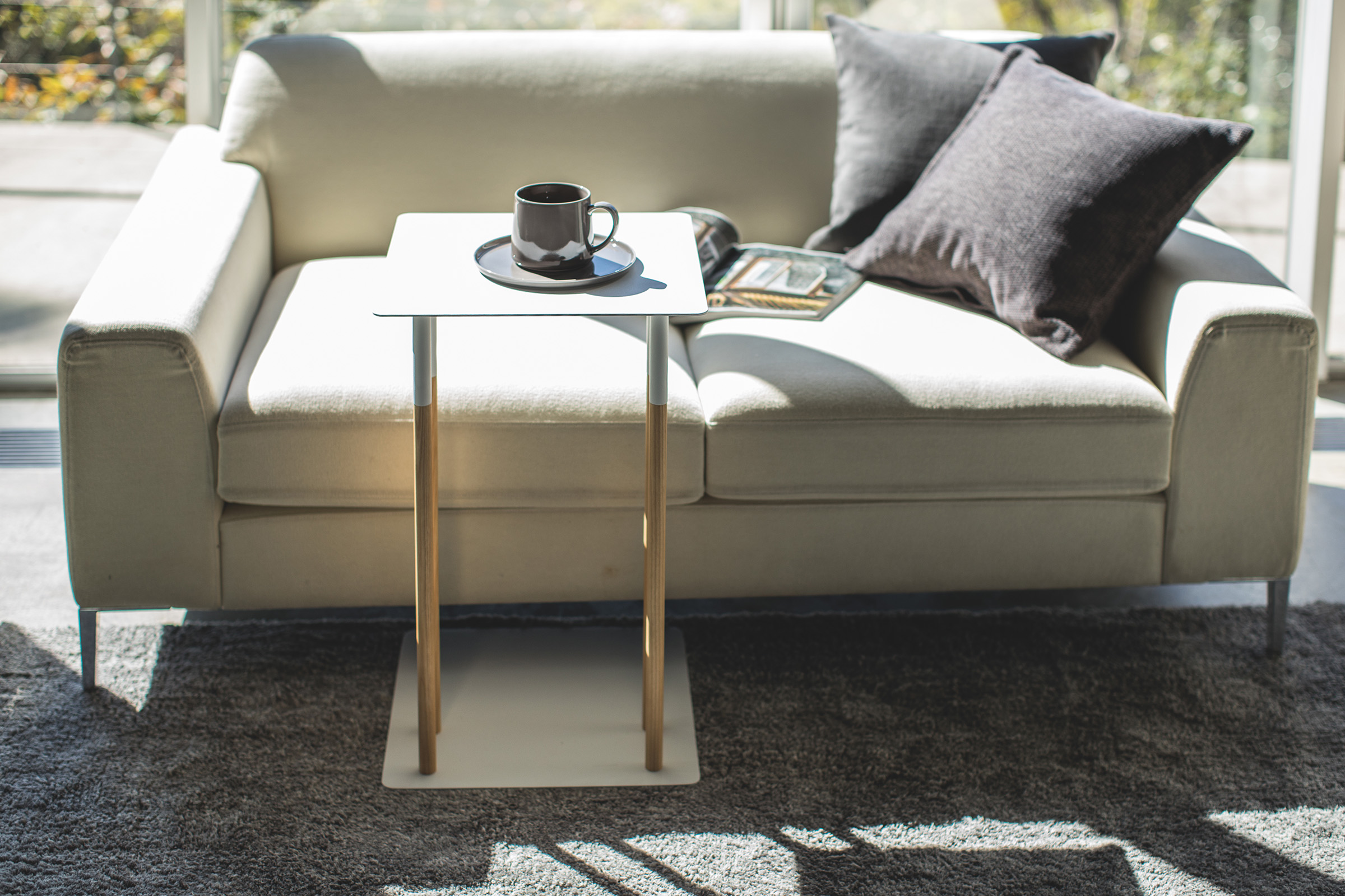 White C Side Table holding coffee cup in living room by Yamazaki Home.