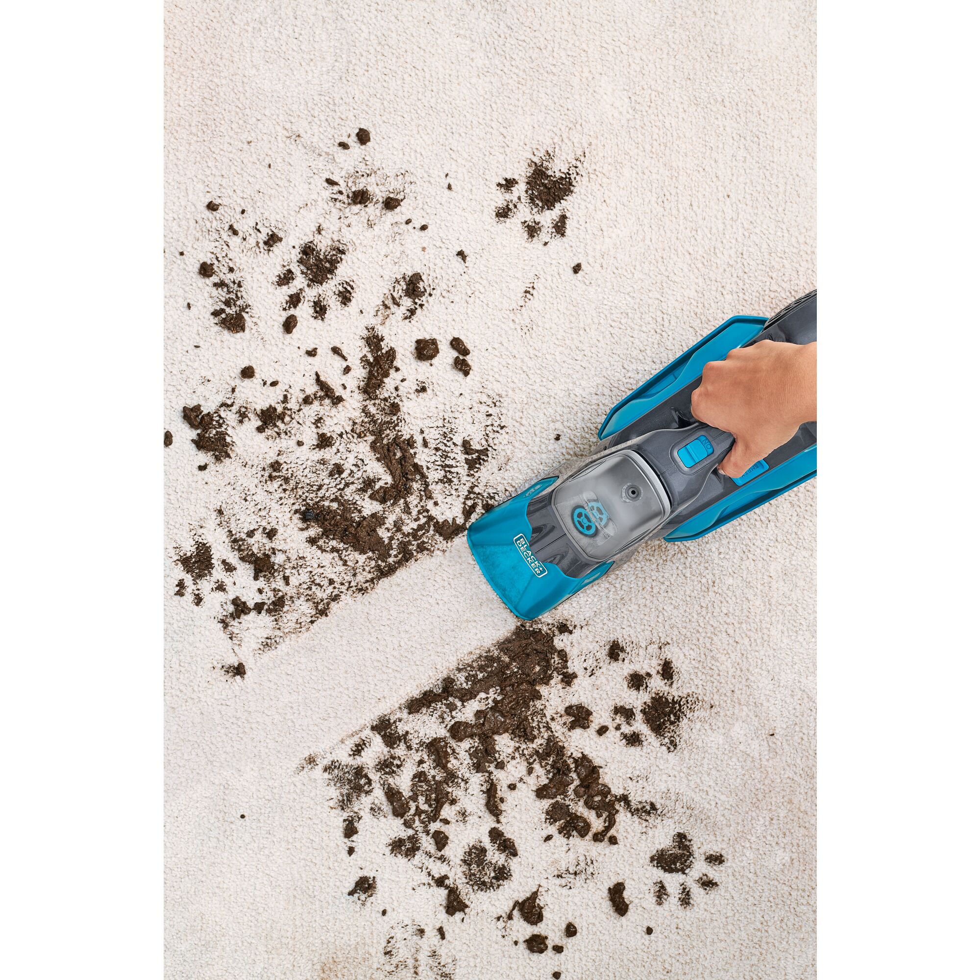 Spillbuster Cordless Spill plus Spot Cleaner being used for cleaning dirt from carpet.