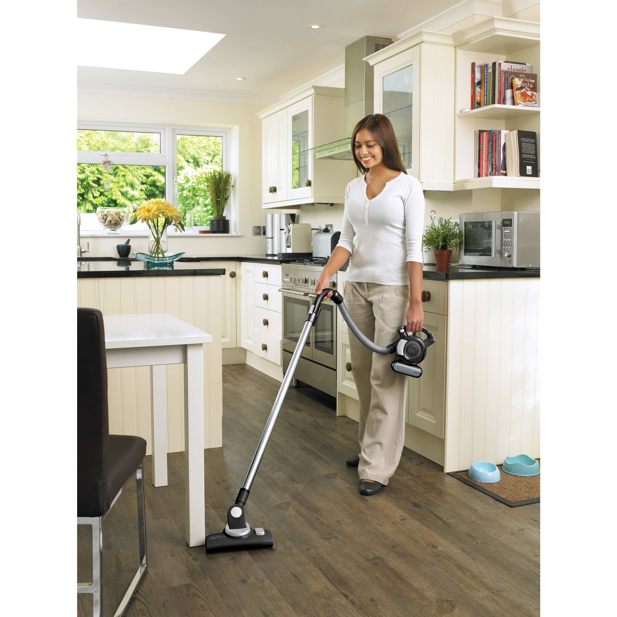 Dustbuster flex cordless hand vacuum being used by a person to clean floor.\n