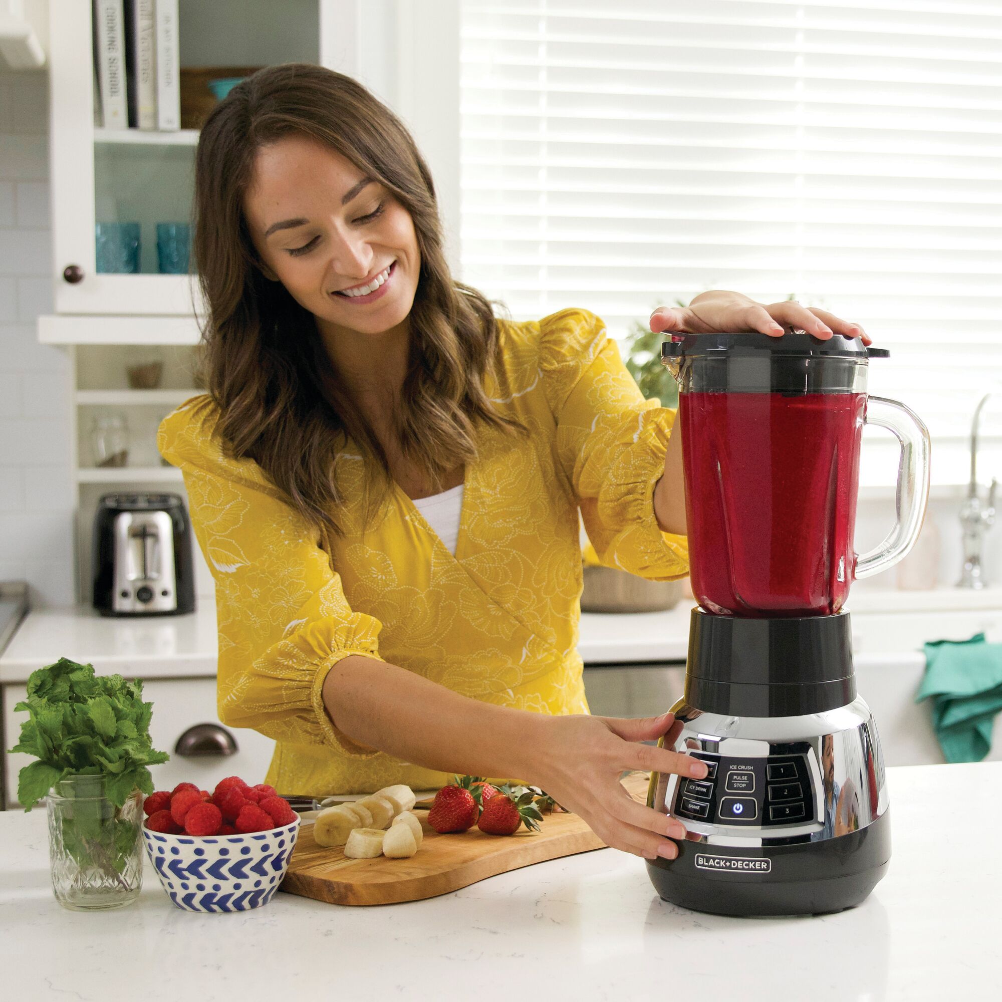 Woman using the BLACK+DECKER blender to make a smoothie