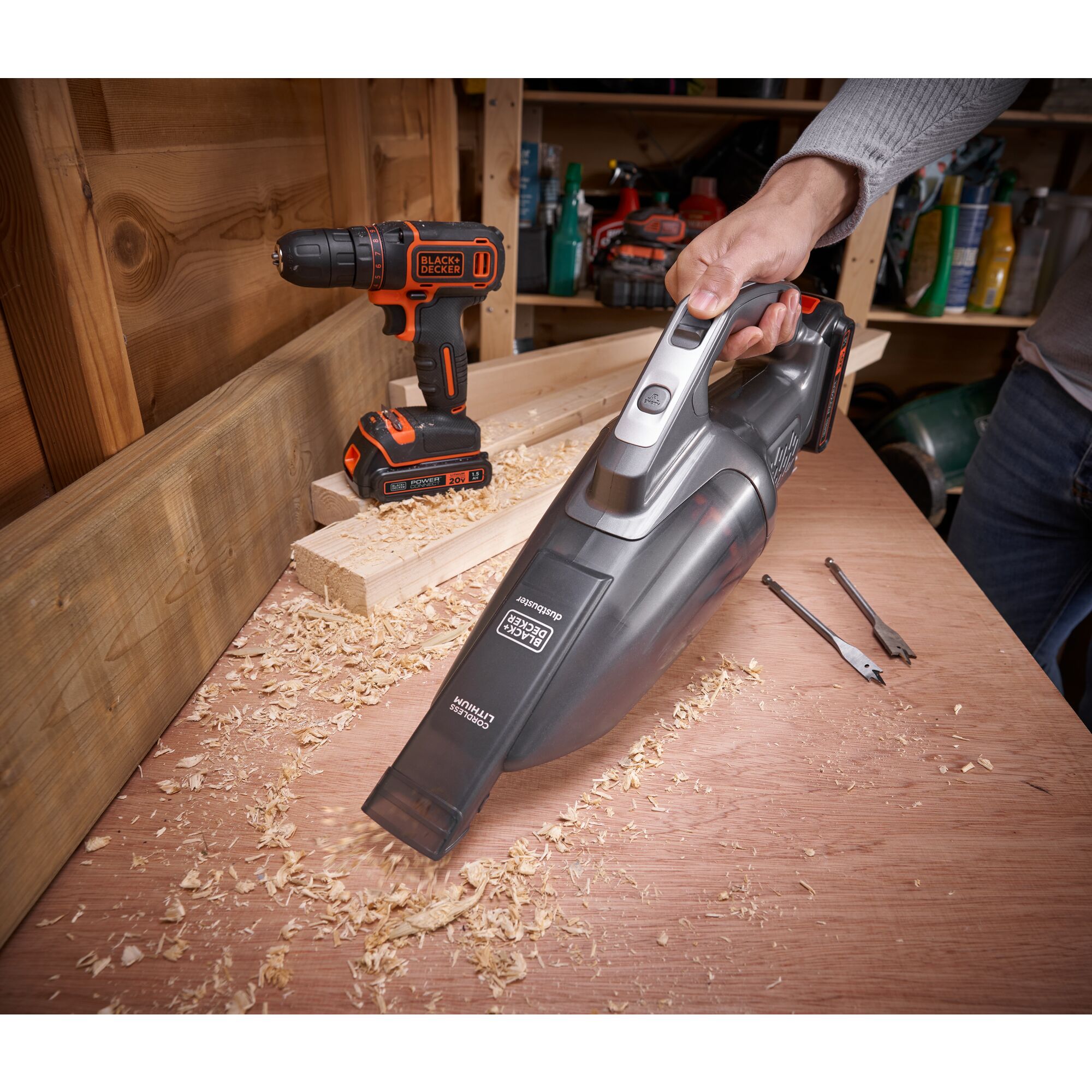 20 volt Powerconnect hand vacuum being used to clean wood chips off of a worktable