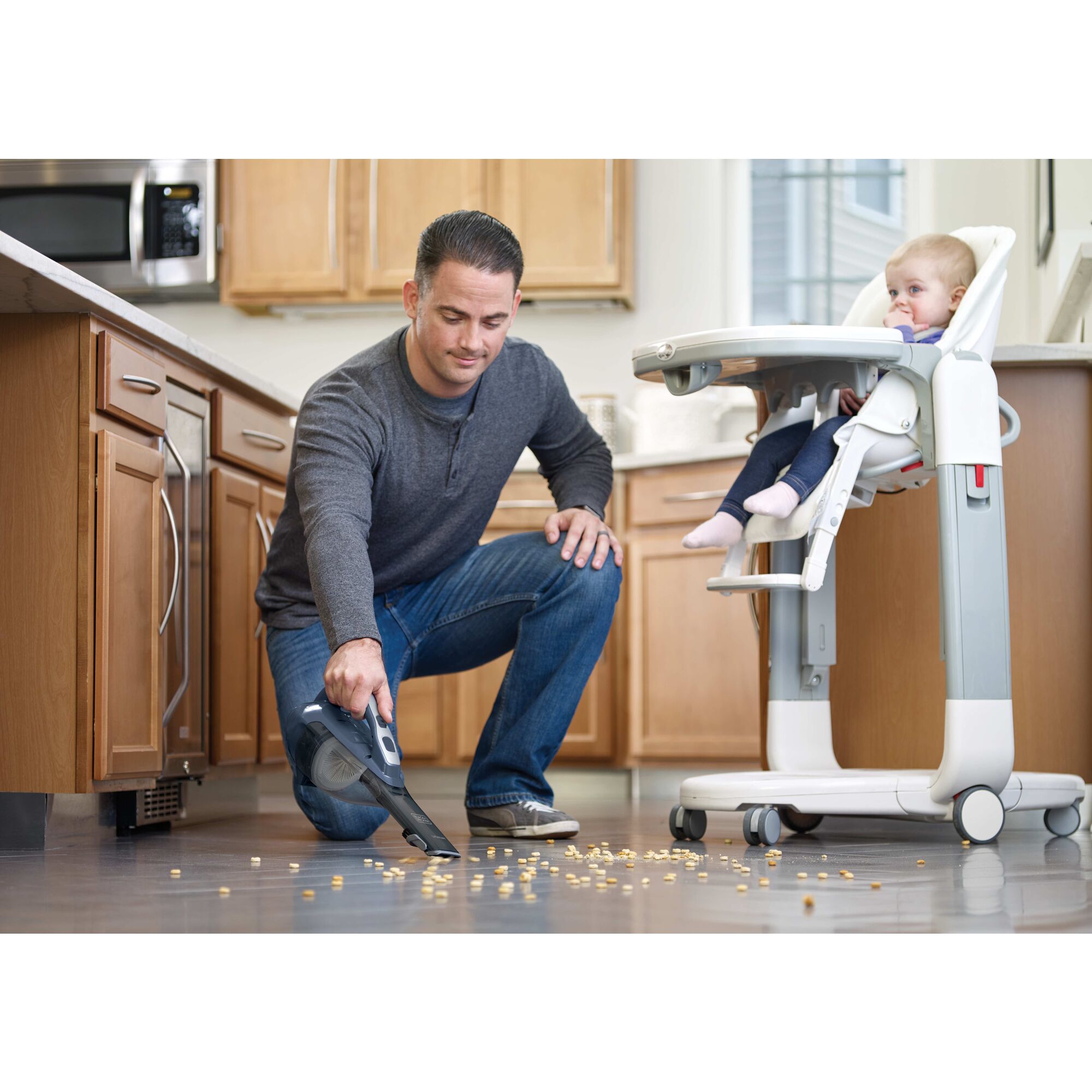 dustbuster Advanced Clean cordless hand vacuum being used by a person to clean floor.