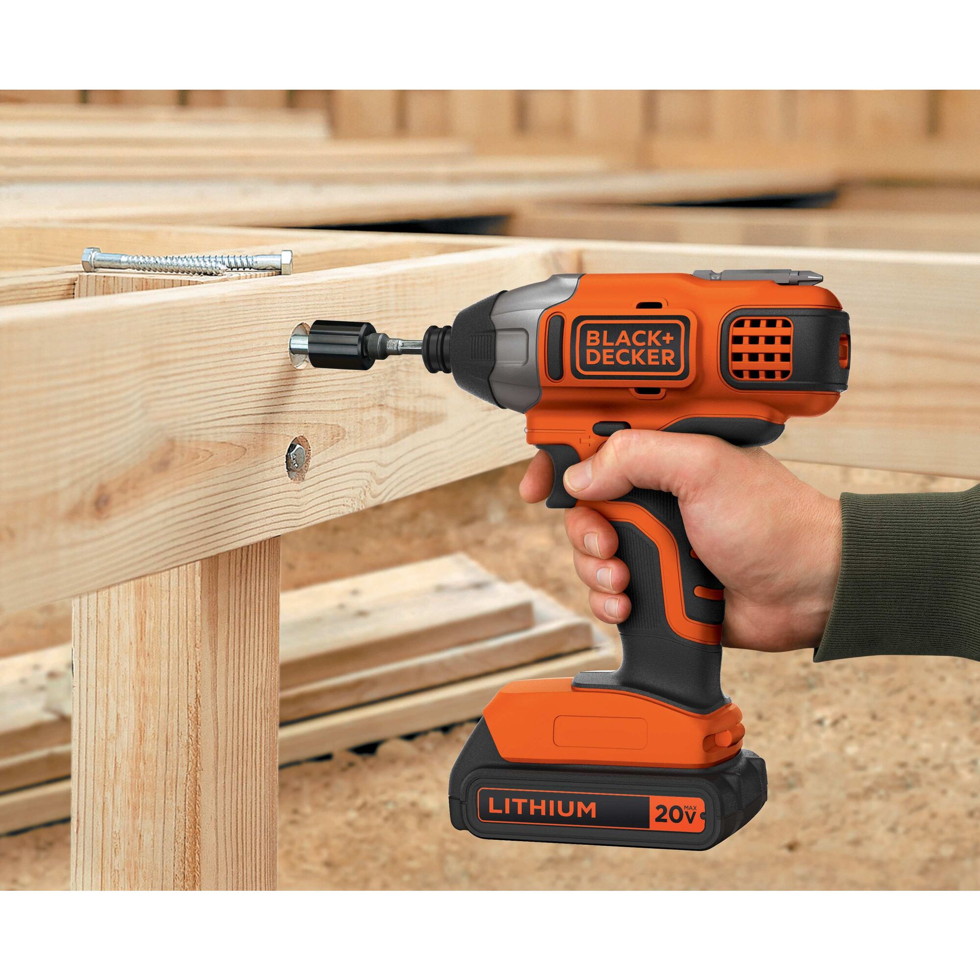 Lithium Impact Driver being used to drive screws in wooden structure.