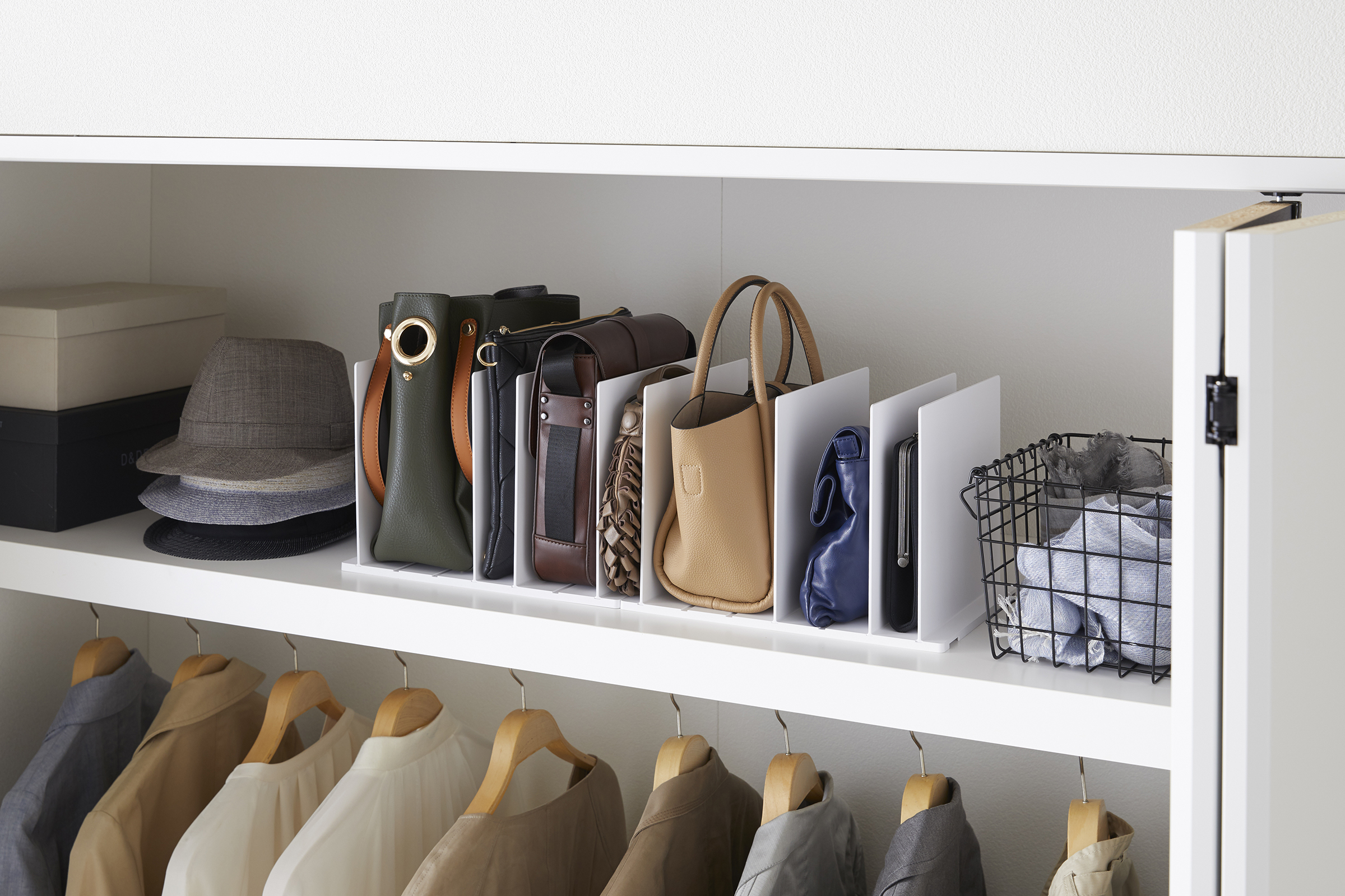 Yamazaki Home white Handbag Organizer storing purses and bags on closet shelf.
