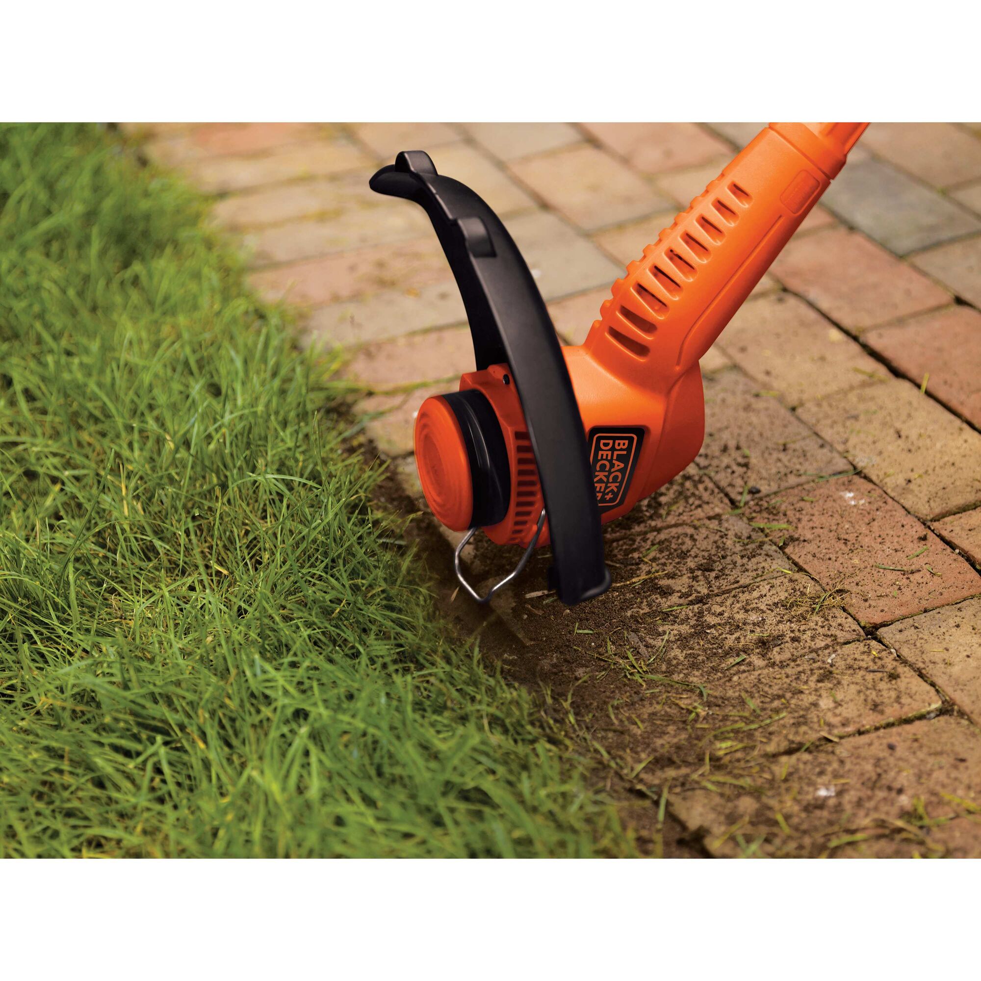 Close-up of 2-in-1 Electric Trimmer/Edger being used to edge next to a sidewalk.