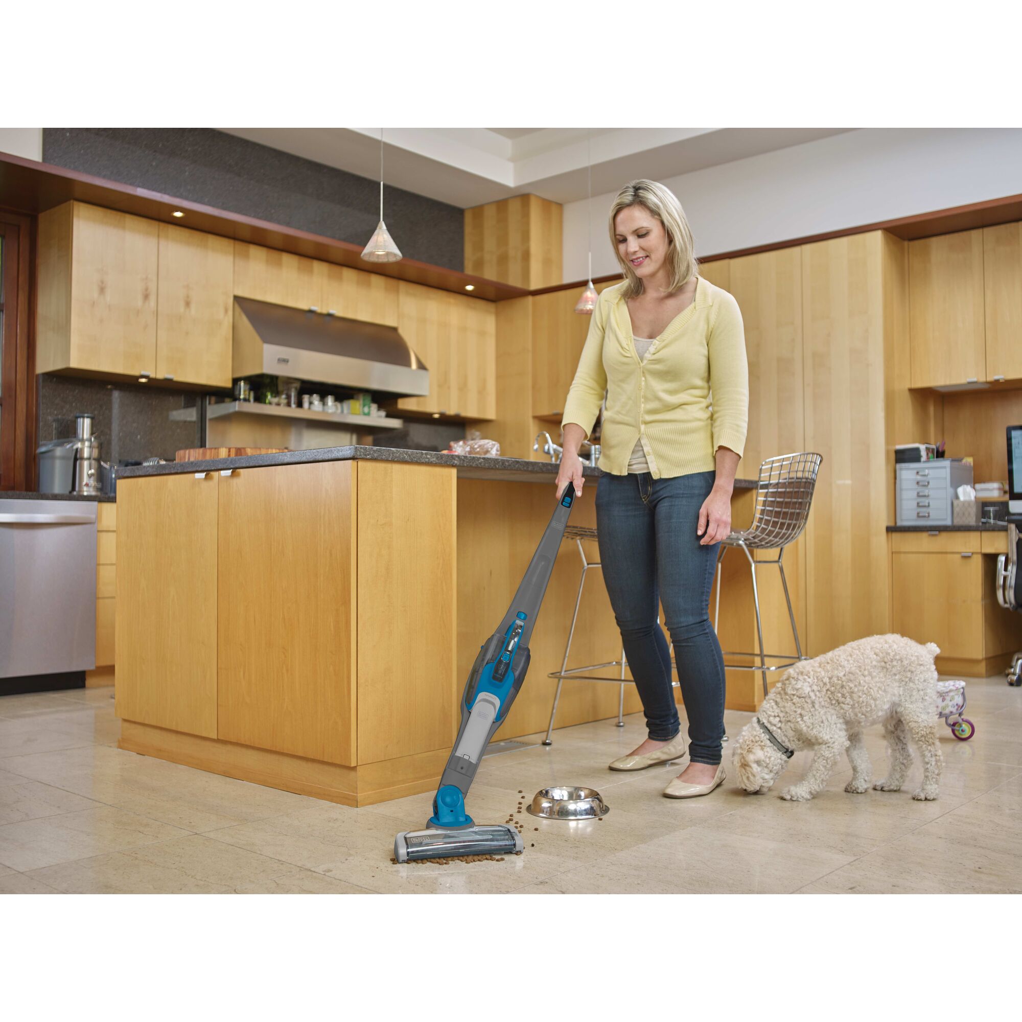 Cordless Lithium 2 in 1 Stick Vacuum being used for cleaning pet food.