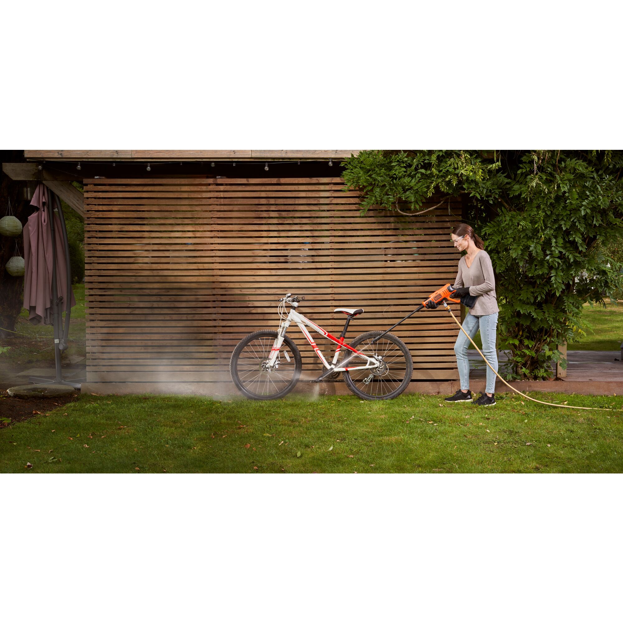Cordless Power Cleaner Kit being used by person to clean bicycle.