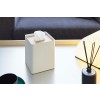 White Square Tissue Case holding tissues on coffee table by Yamazaki Home.