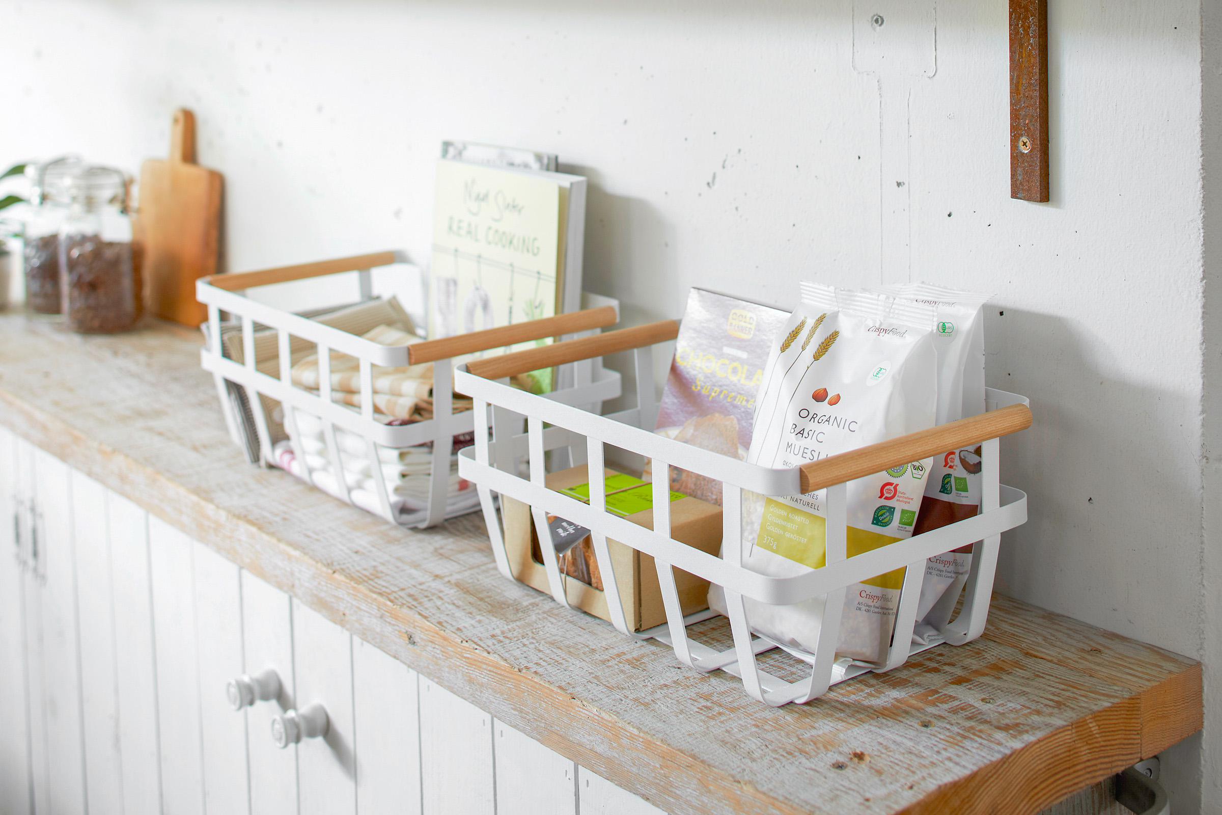 Storage Basket containing food items on shelf by Yamazaki Home.