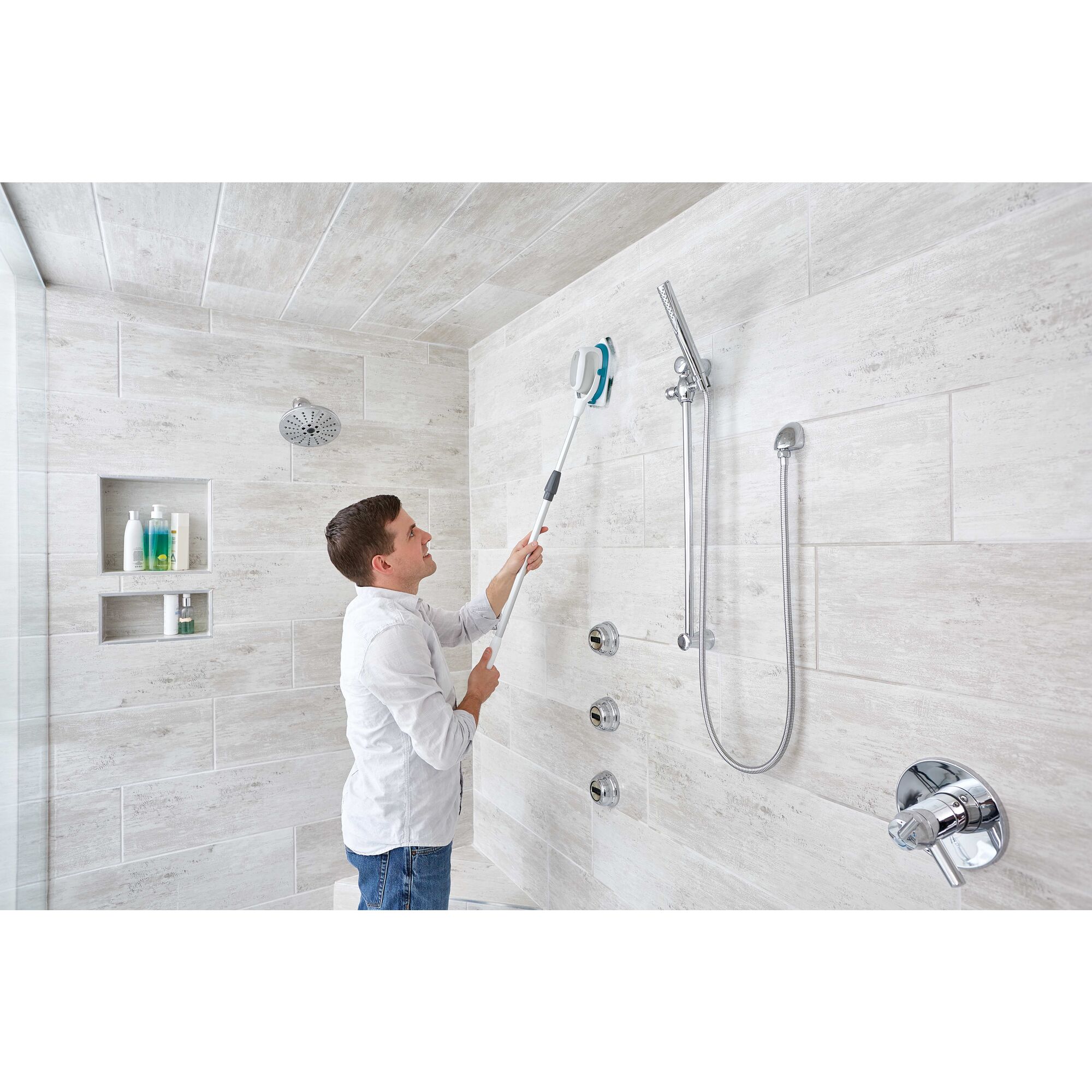 Scumbuster Pro Rechargeable Powered Scrubber with Extension Pole being used for cleaning shower walls.