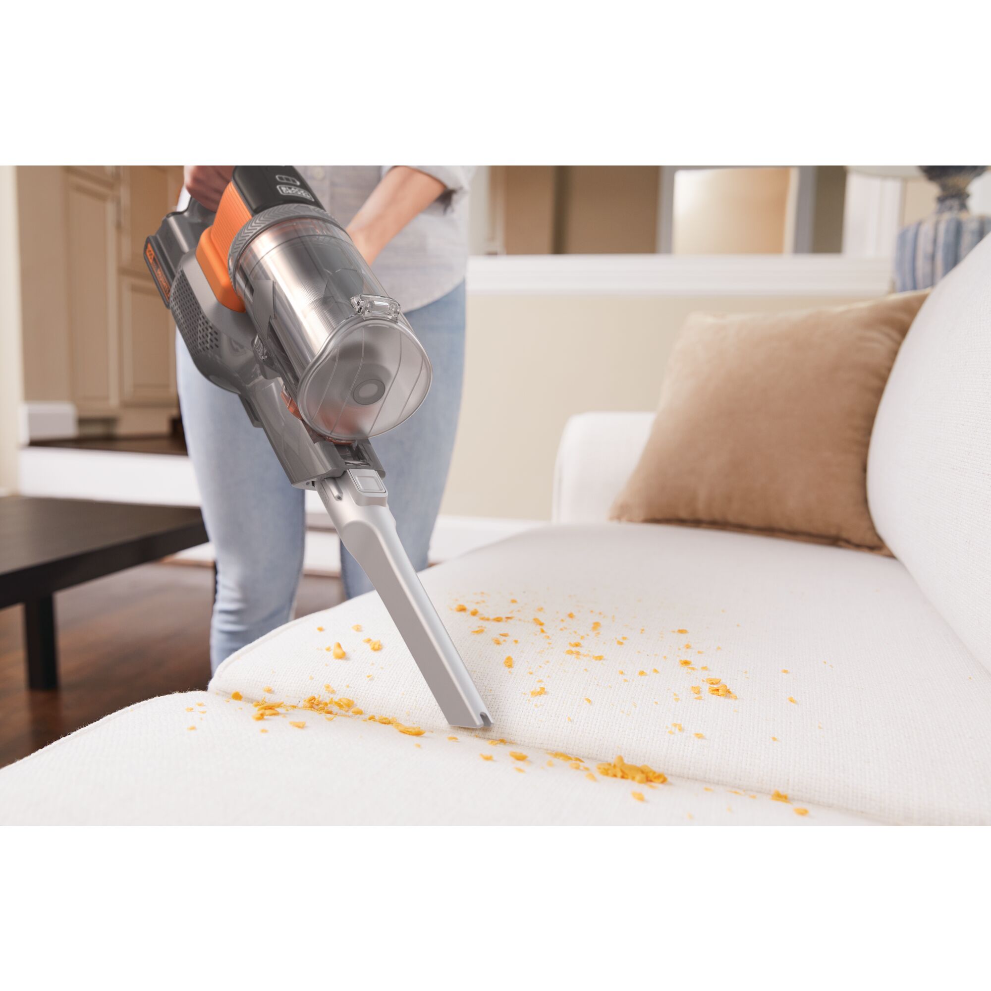 Power Series extreme cordless stick vacuum cleaner cleaning mess from sofa.