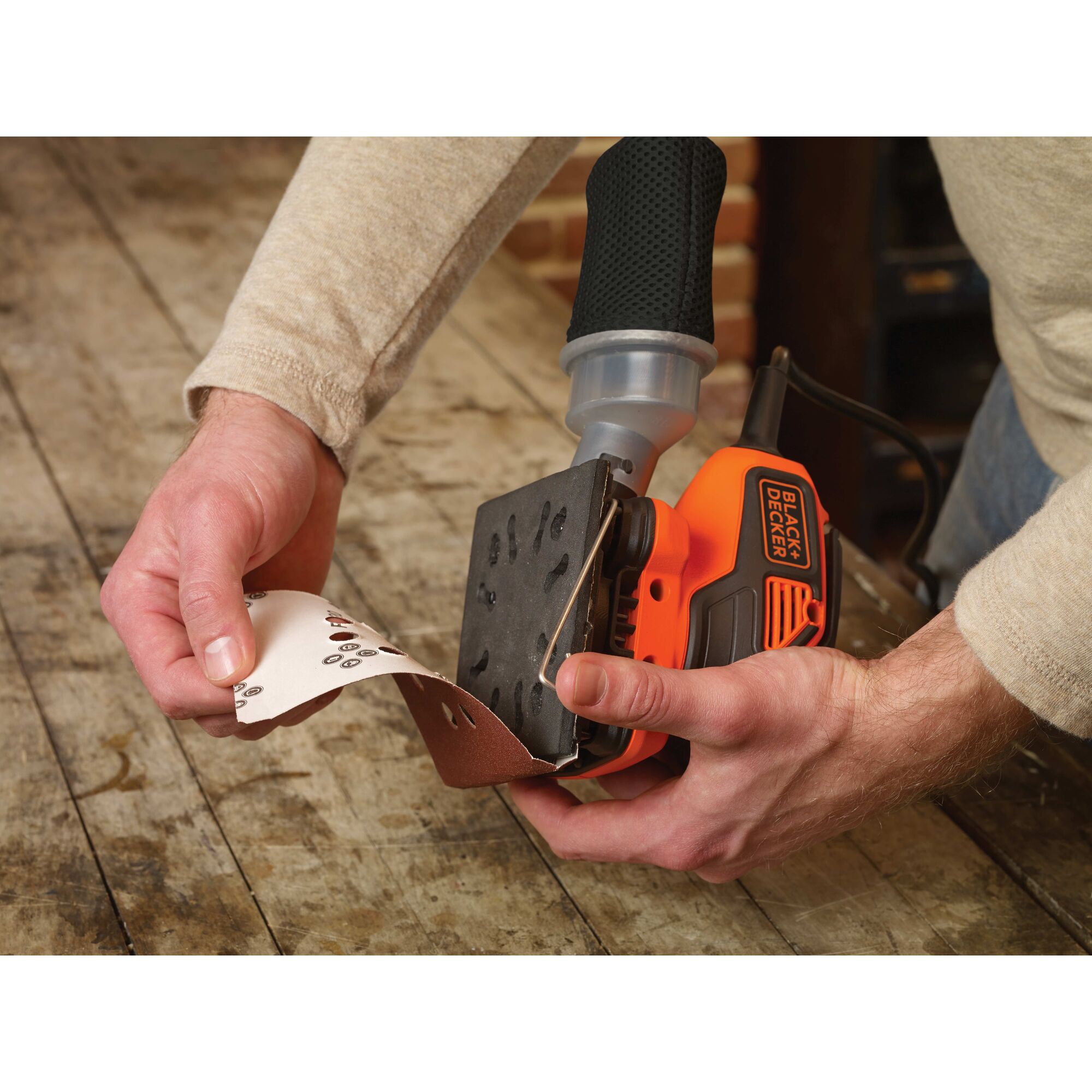 Changeable sandpaper feature of a quarter sheet orbital sander with paddle switch actuation.