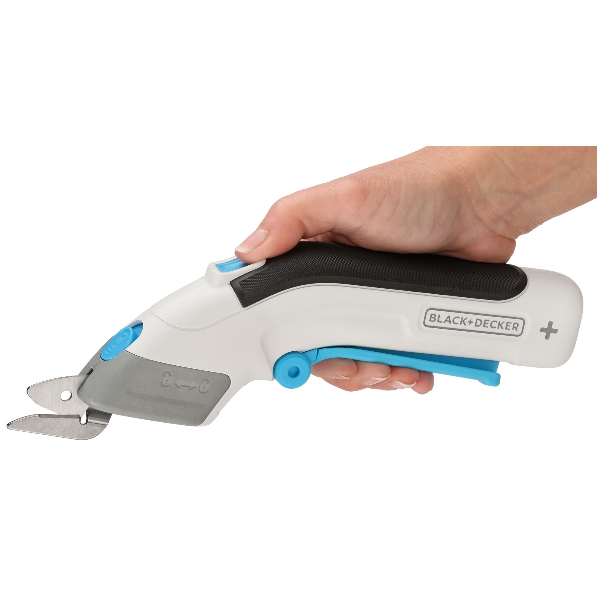 woman holding BLACK+DECKER cordless power scissors with finger on safety lock