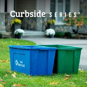 durable HDPE blue plastic recycling container with we recycled on the side sitting on a residential front lawn