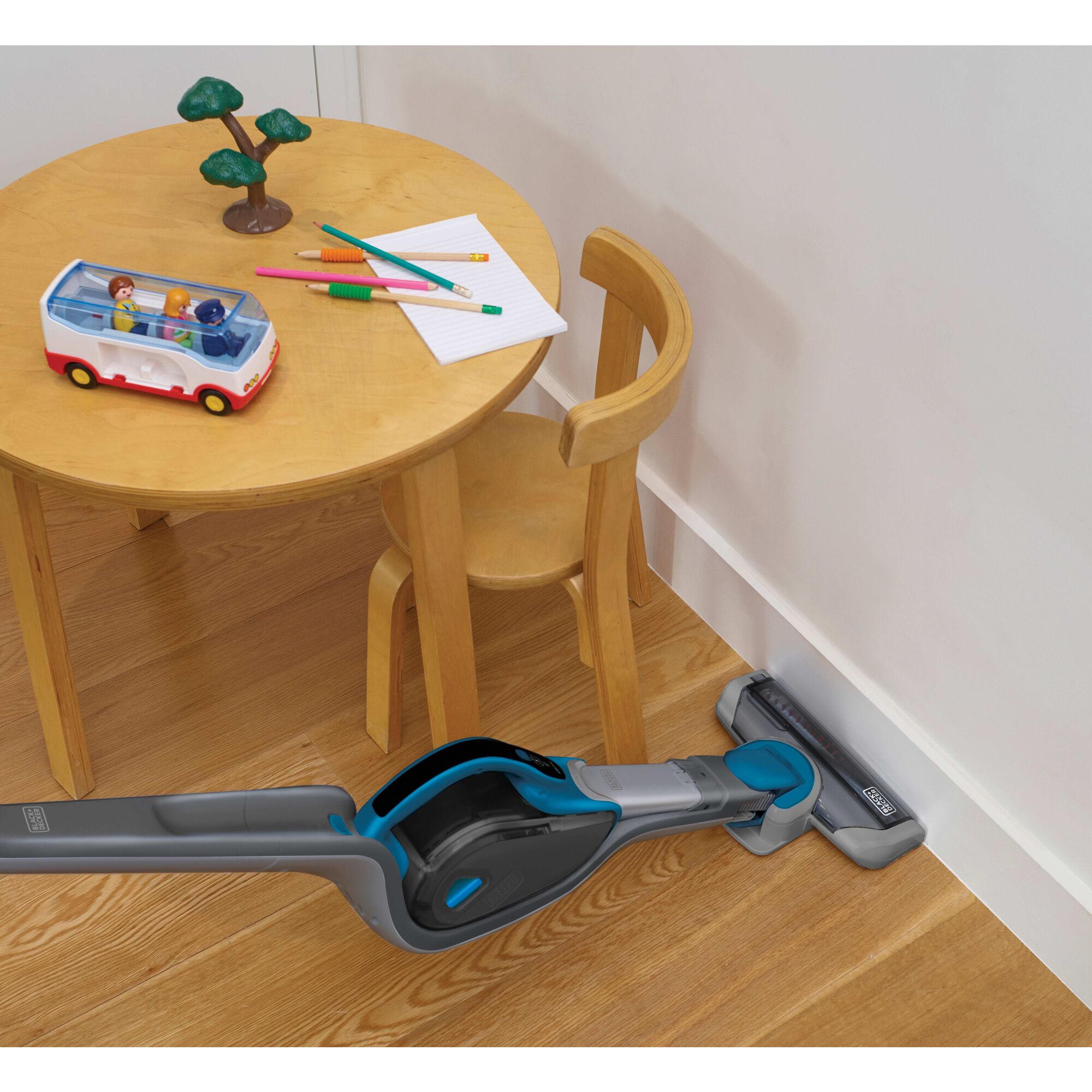 Cordless Lithium 2 in 1 Stick Vacuum being used to clean room corners.