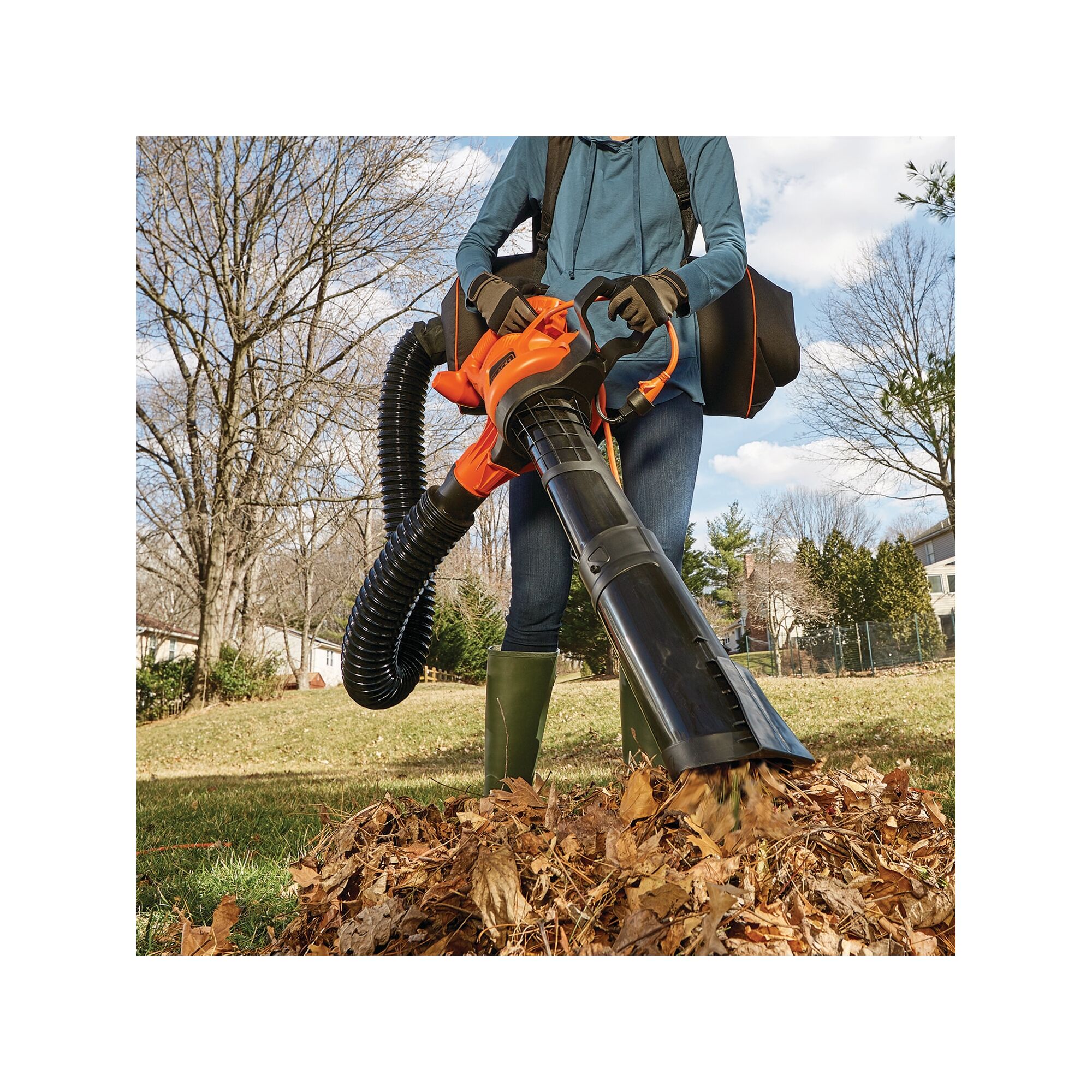 3 in 1 VAC PACK 12 Amp Leaf Blower Vacuum and Mulcher being used by person to clear dried leaves outdoors.