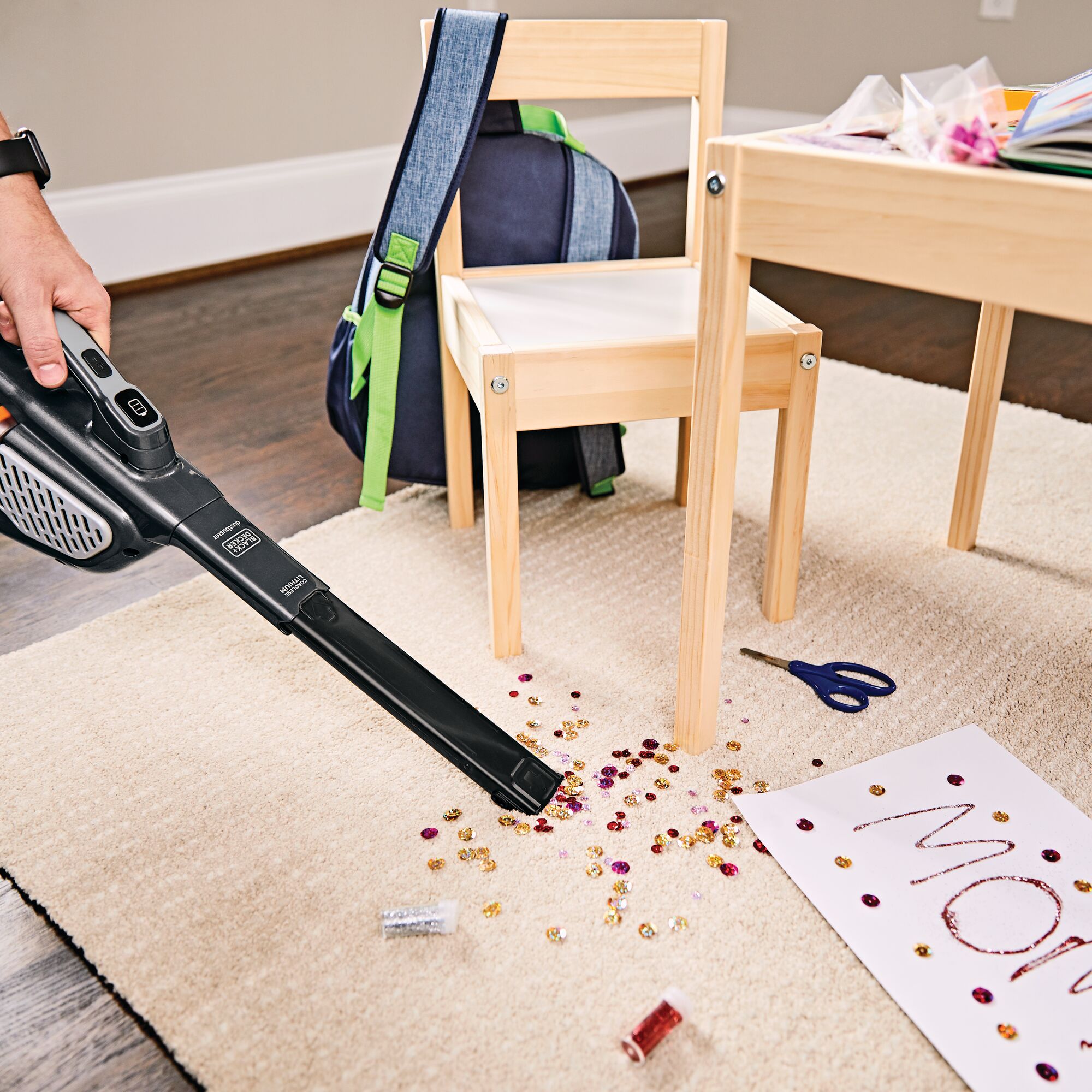 16 Volt MAX dustbuster Advanced Clean plus Hand Vacuum being used to clean mess from carpet after children have done their crafts.