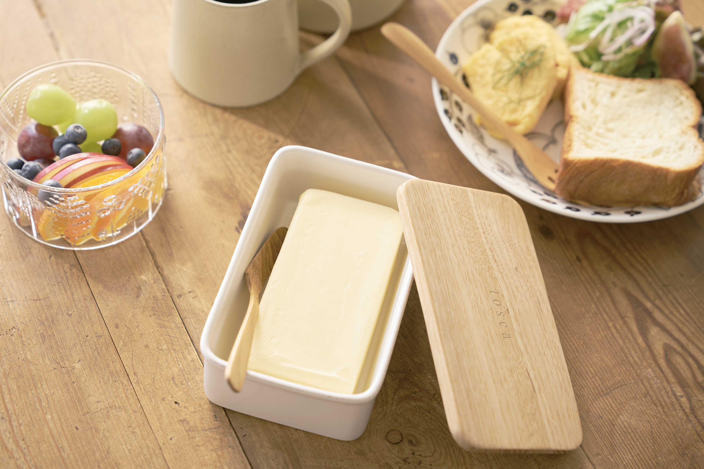 Aerial view of ceramic butter dish holding butter on breakfast table by Yamazaki Home.