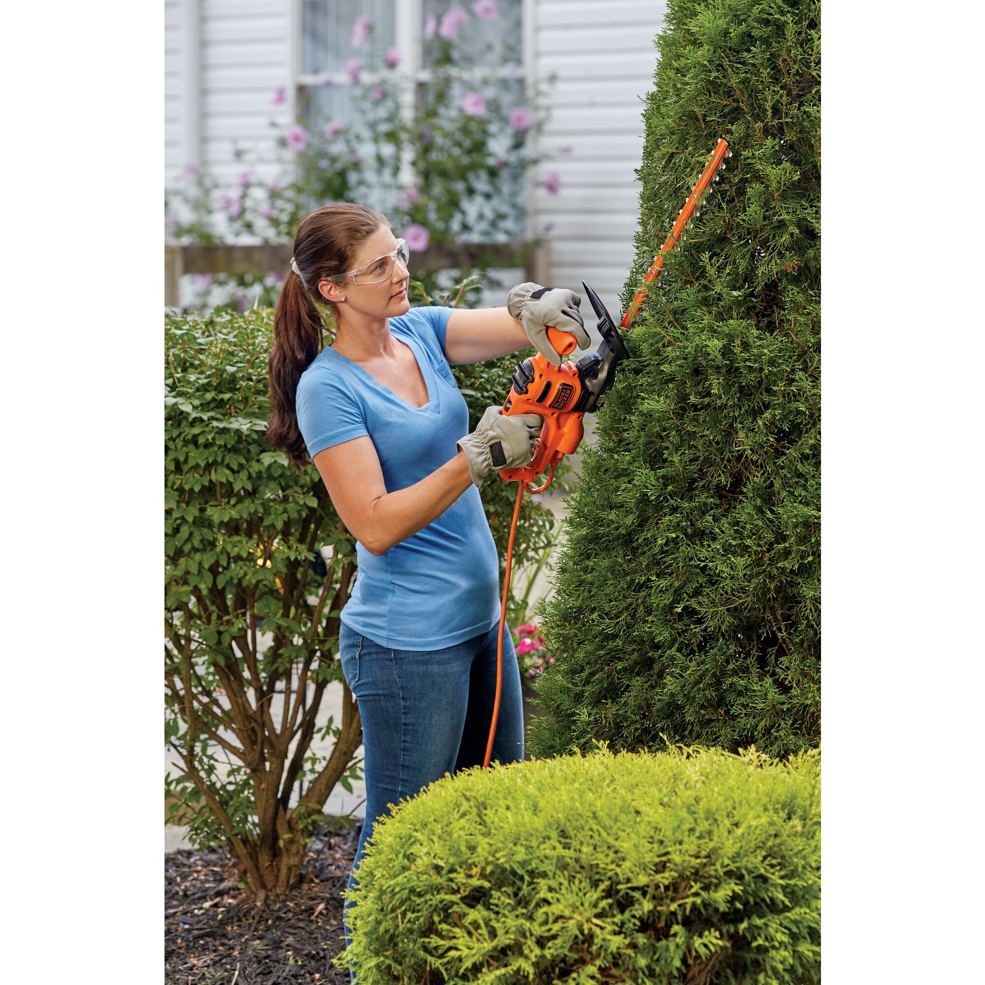 17 inch Electric Hedge Trimmer being used by person to trim hedge outdoors.