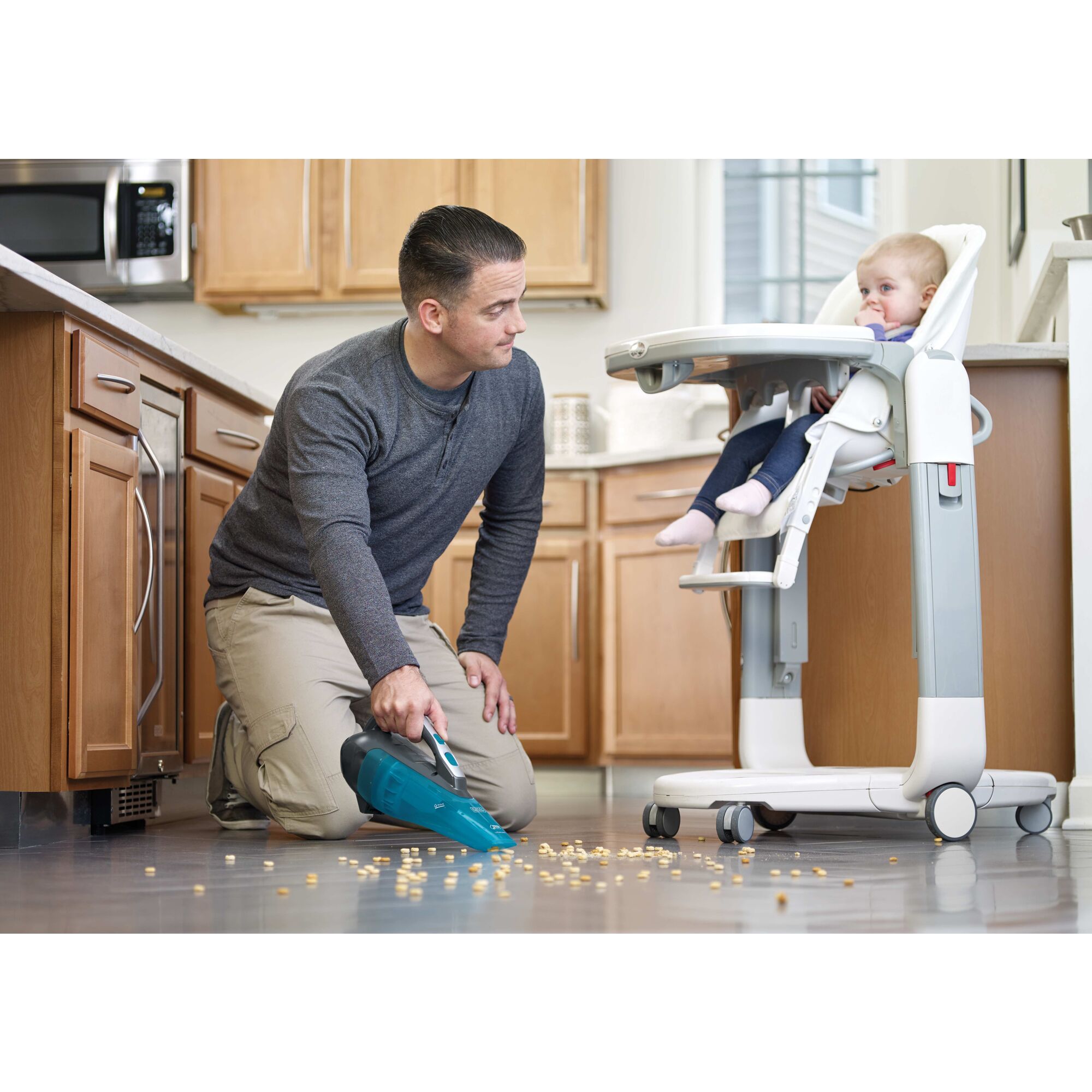 Dustbuster Advanced Clean Wet and Dry Cordless Hand Vacuum being used for cleaning spilled baby food from floor.