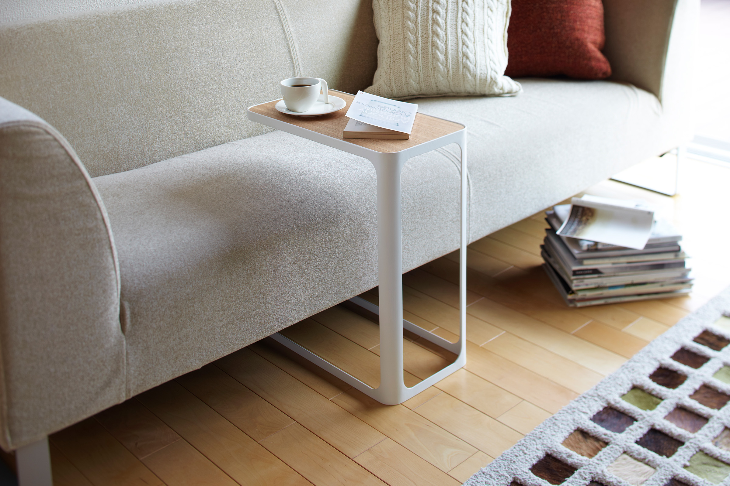 White C Side Table displaying coffee cup and book in living room by Yamazaki Home.