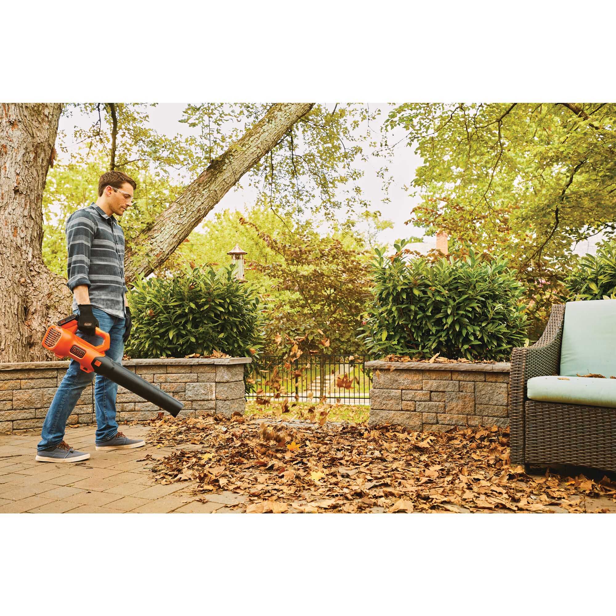Axial Leaf Blower being used for blowing away dead leaves by person.