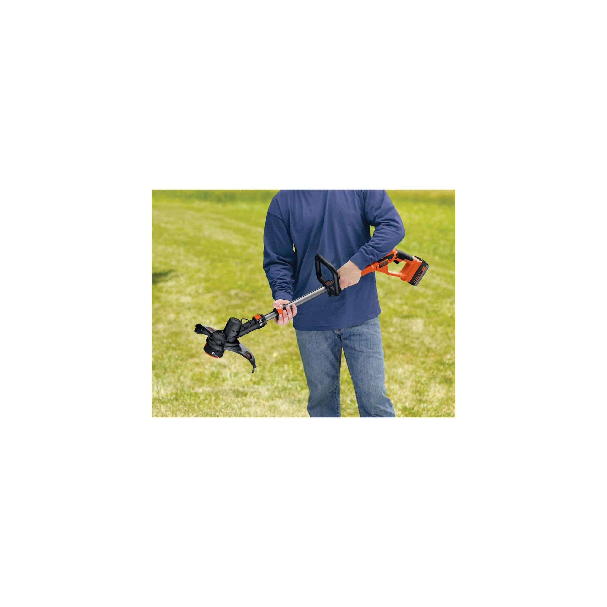 Person standing outside holding string trimmer