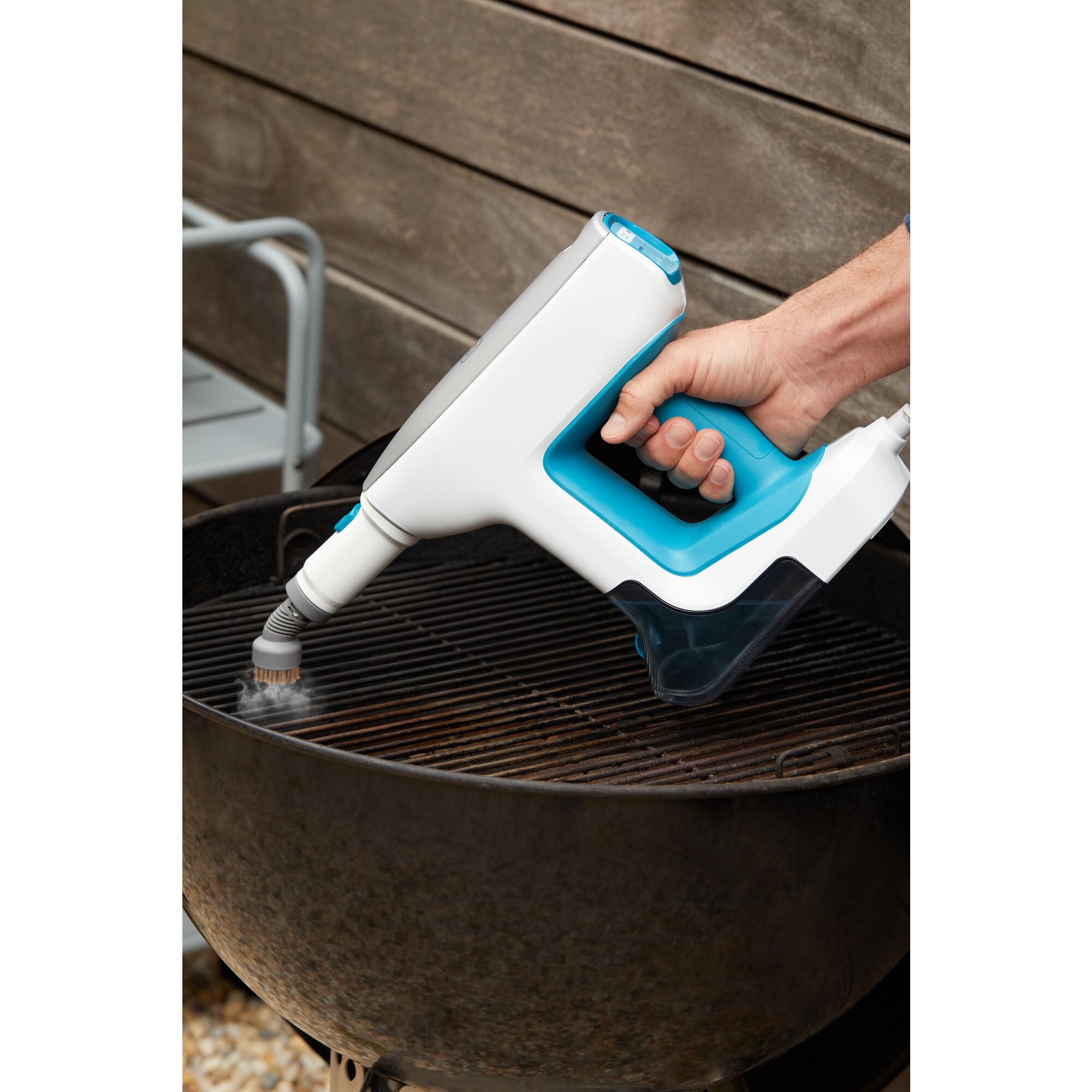 Woman cleaning bathroom sink with steam mop accessory