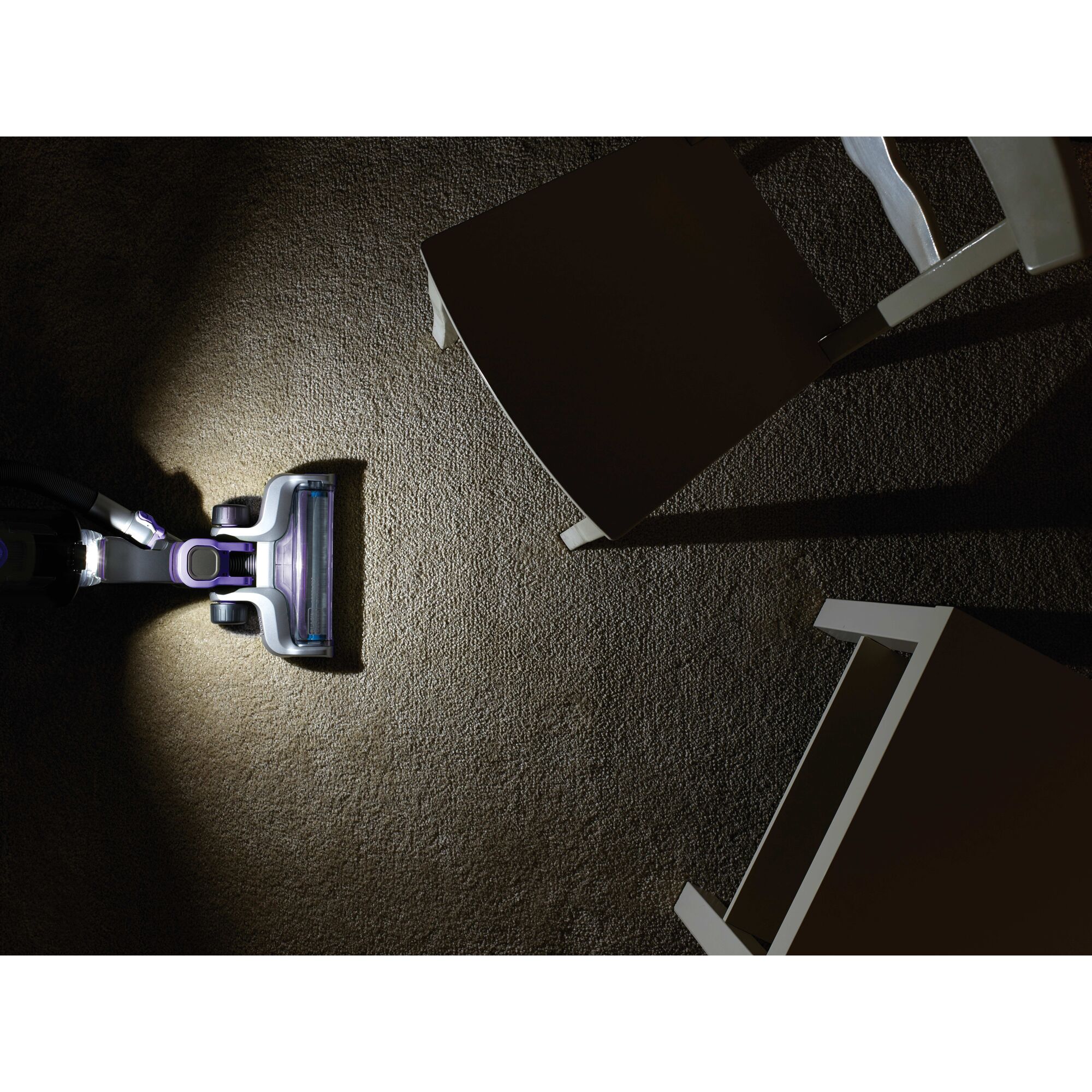 POWER SERIES PRO Cordless 2 in 1 Pet Vacuum being used for cleaning in dark using L E D light.