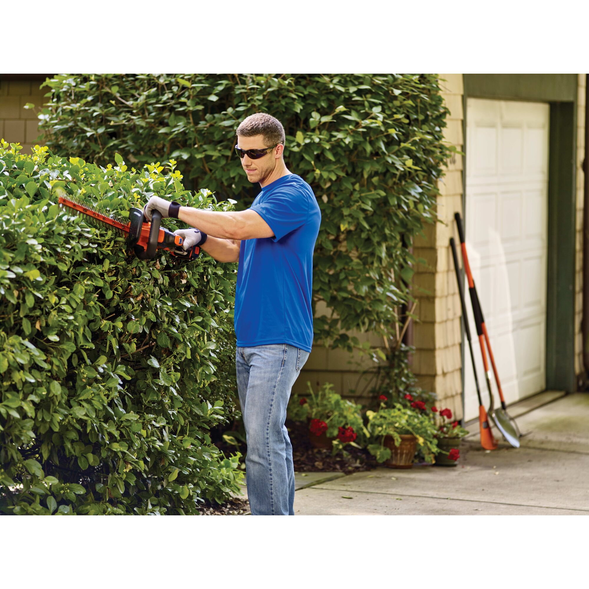 40 volt lithium 24 inch powercut hedge trimmer being used by a person.