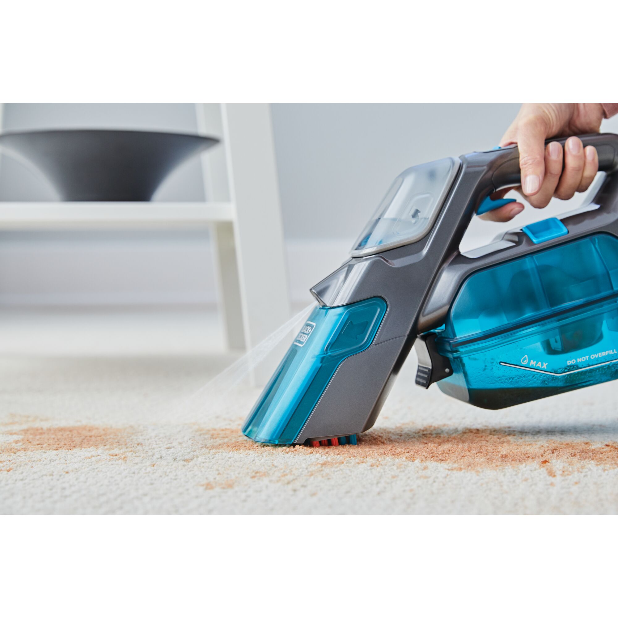 Black and decker Spillbuster Cordless Spill and Spot Cleaner With Extra Filter being used by a person to clean up a mess from a light colored floor